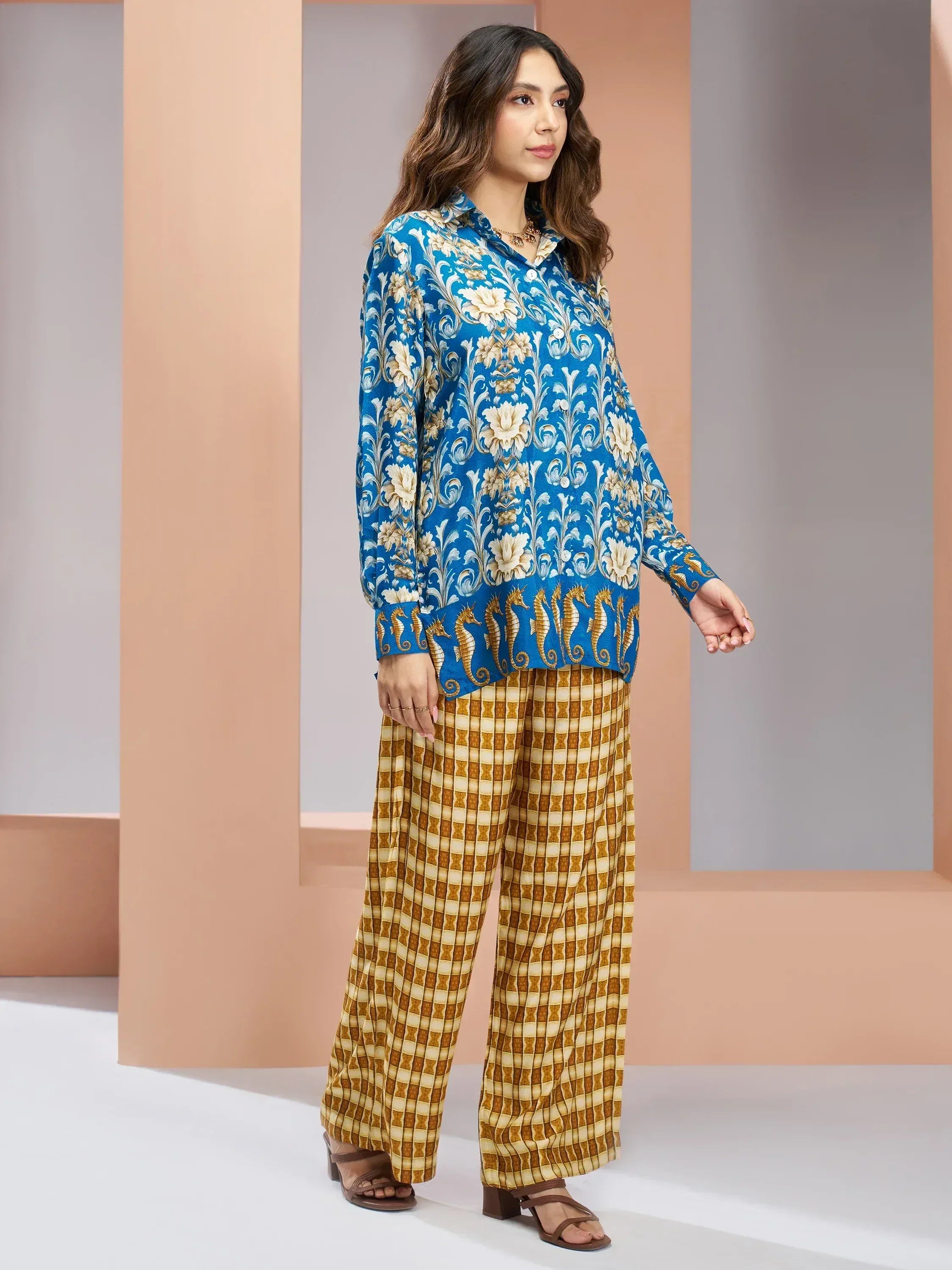 Blue floral print kurta with seahorse hem paired with mustard checkered palazzo pants, ethnic wear