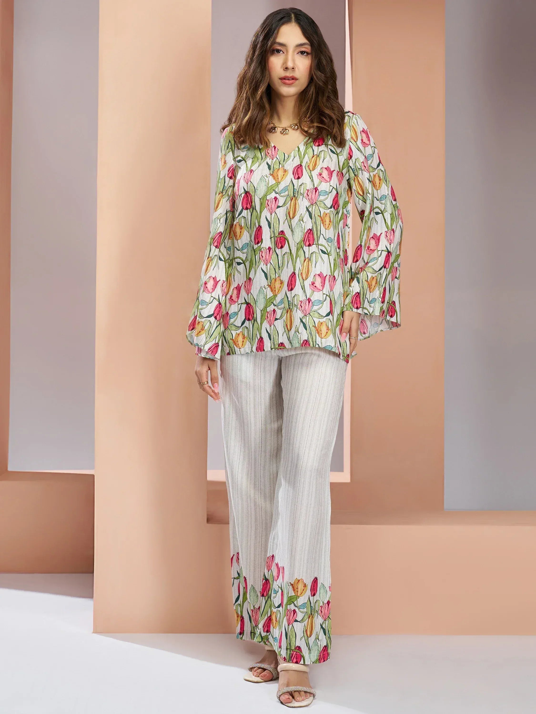 Woman wearing a white floral printed kurta and palazzo set, modern ethnic outfit