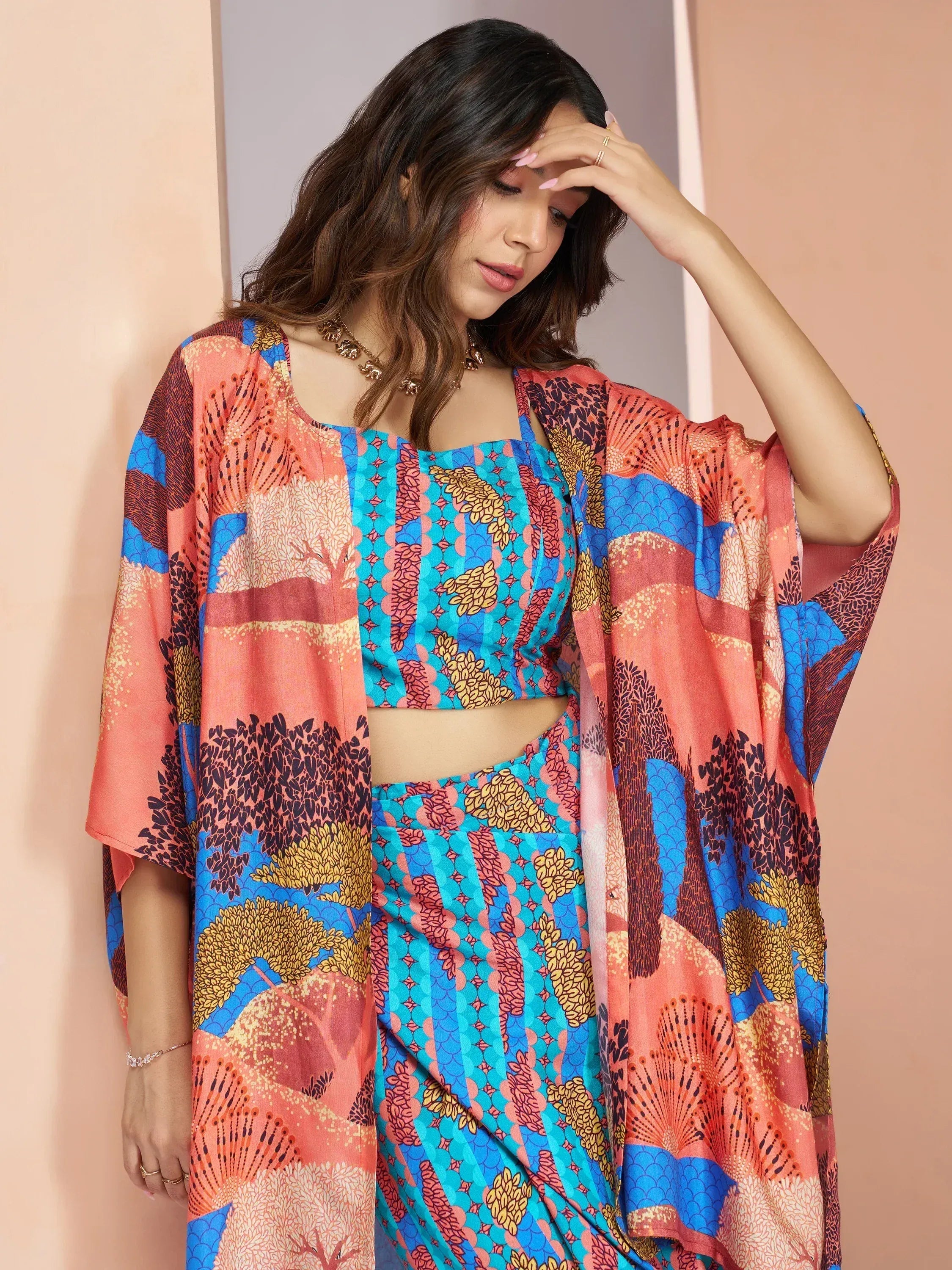 Vibrant printed ethnic gown with matching crop top and drape, perfect for festive occasions