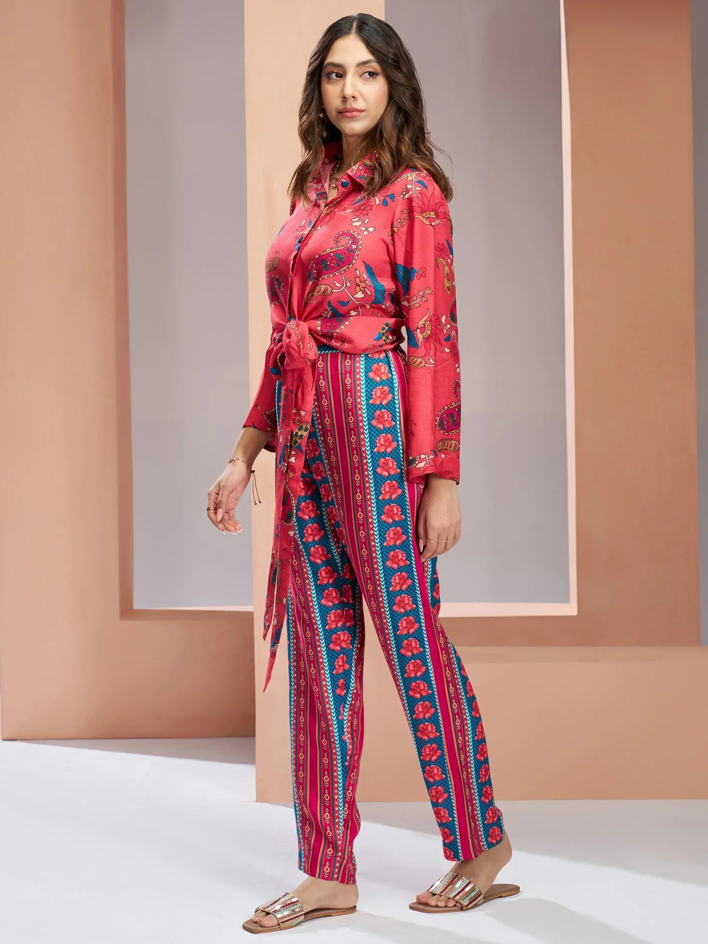 Woman in vibrant Indian ethnic wear, floral print kurta with palazzo pants, perfect for casual occasions.
