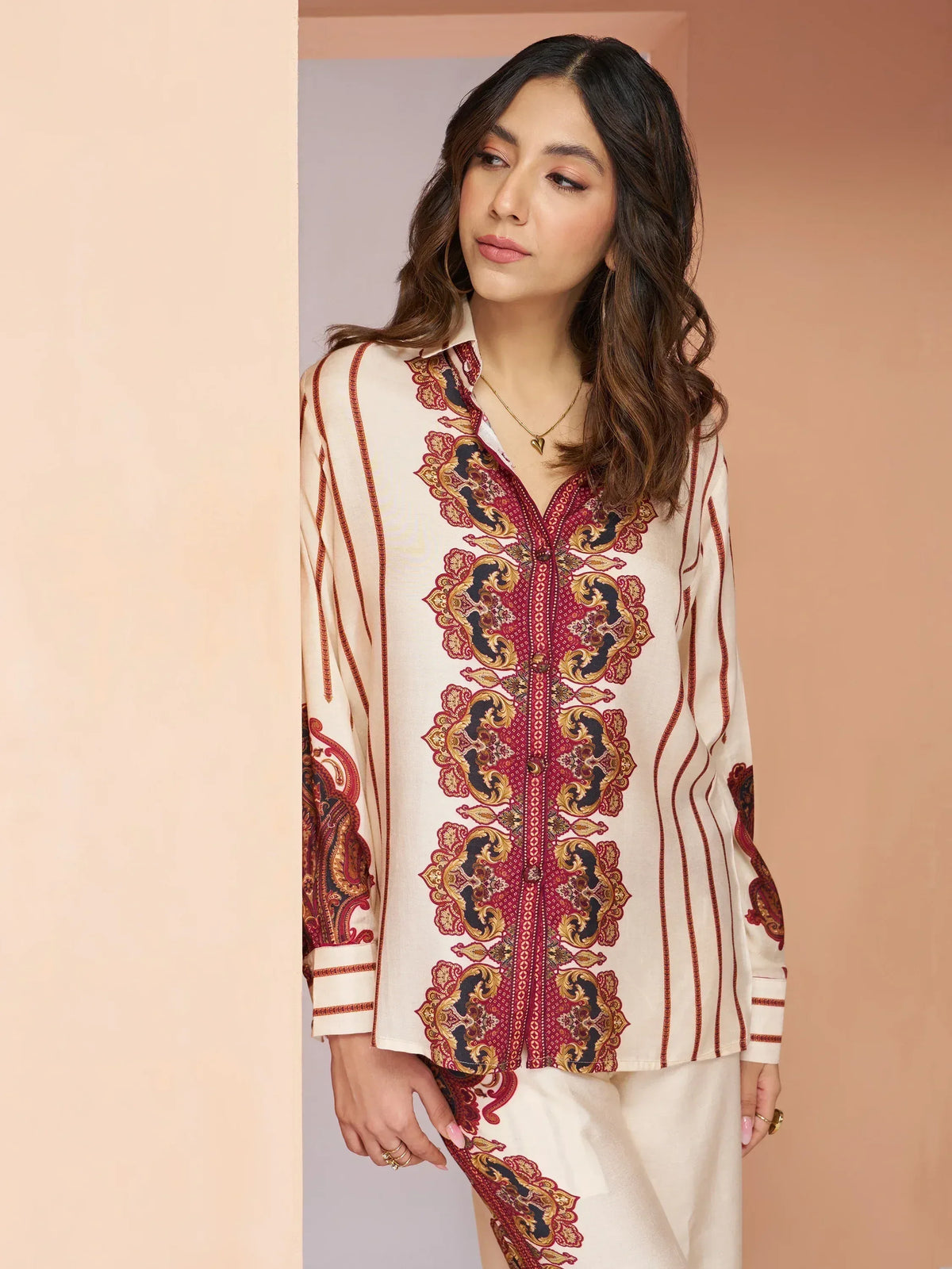 Woman in cream ethnic kurta with red and gold paisley print, matching palazzo pants, Indian designer wear
