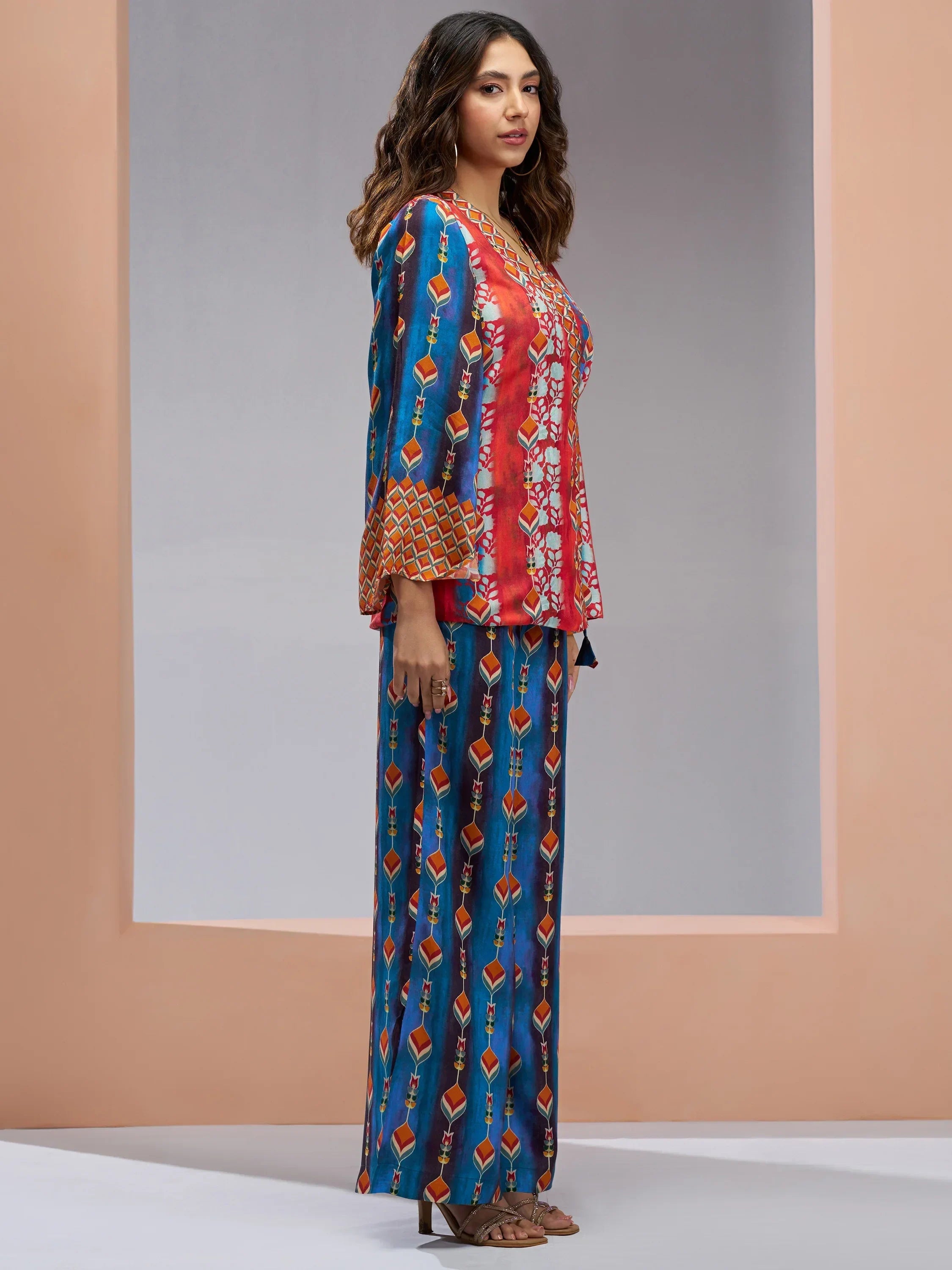 Woman wearing colorful printed ethnic kurta set with wide-leg pants and geometric patterns