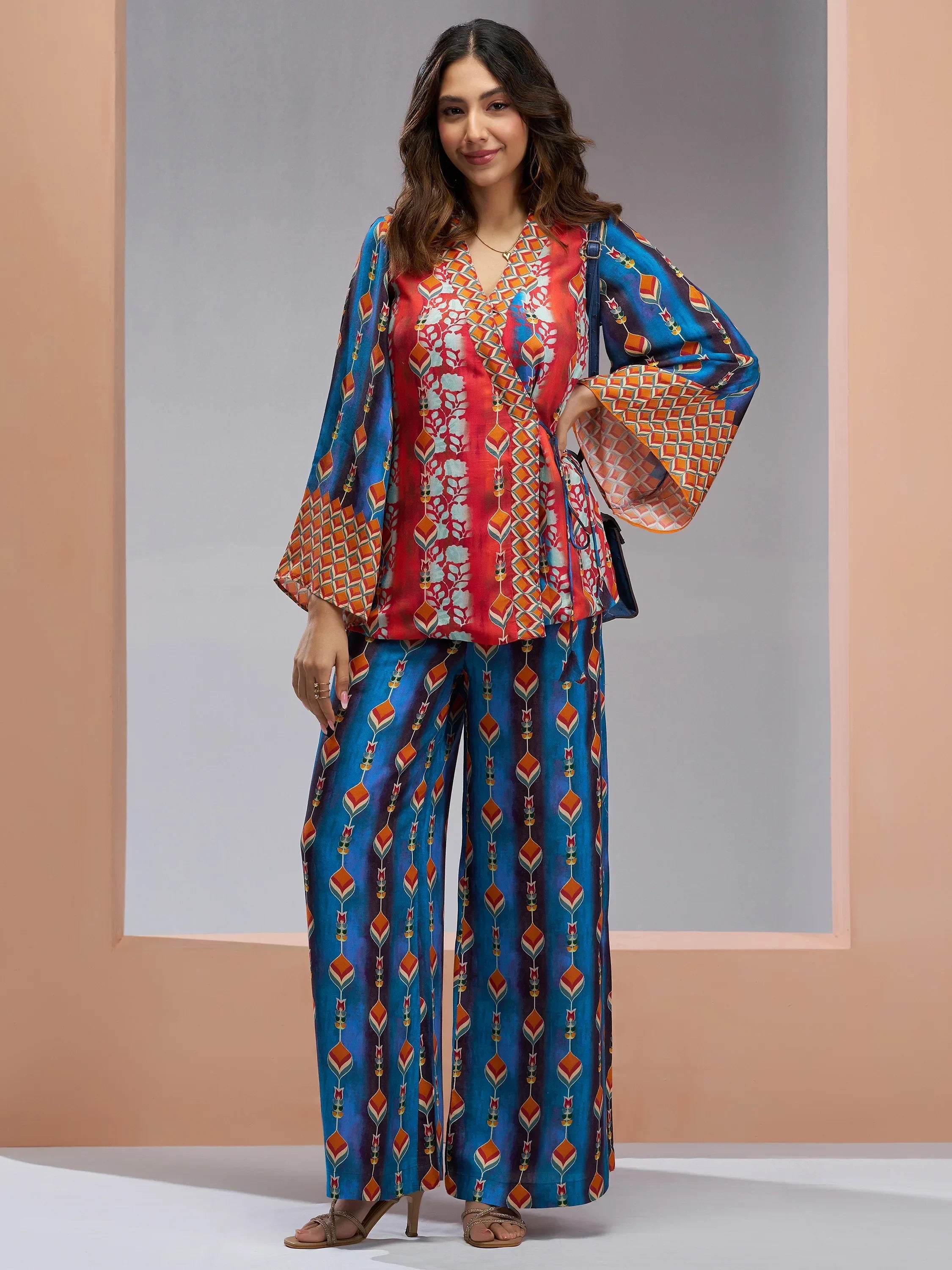 Woman wearing vibrant printed ethnic co-ord set with flared sleeves and wide-leg pants