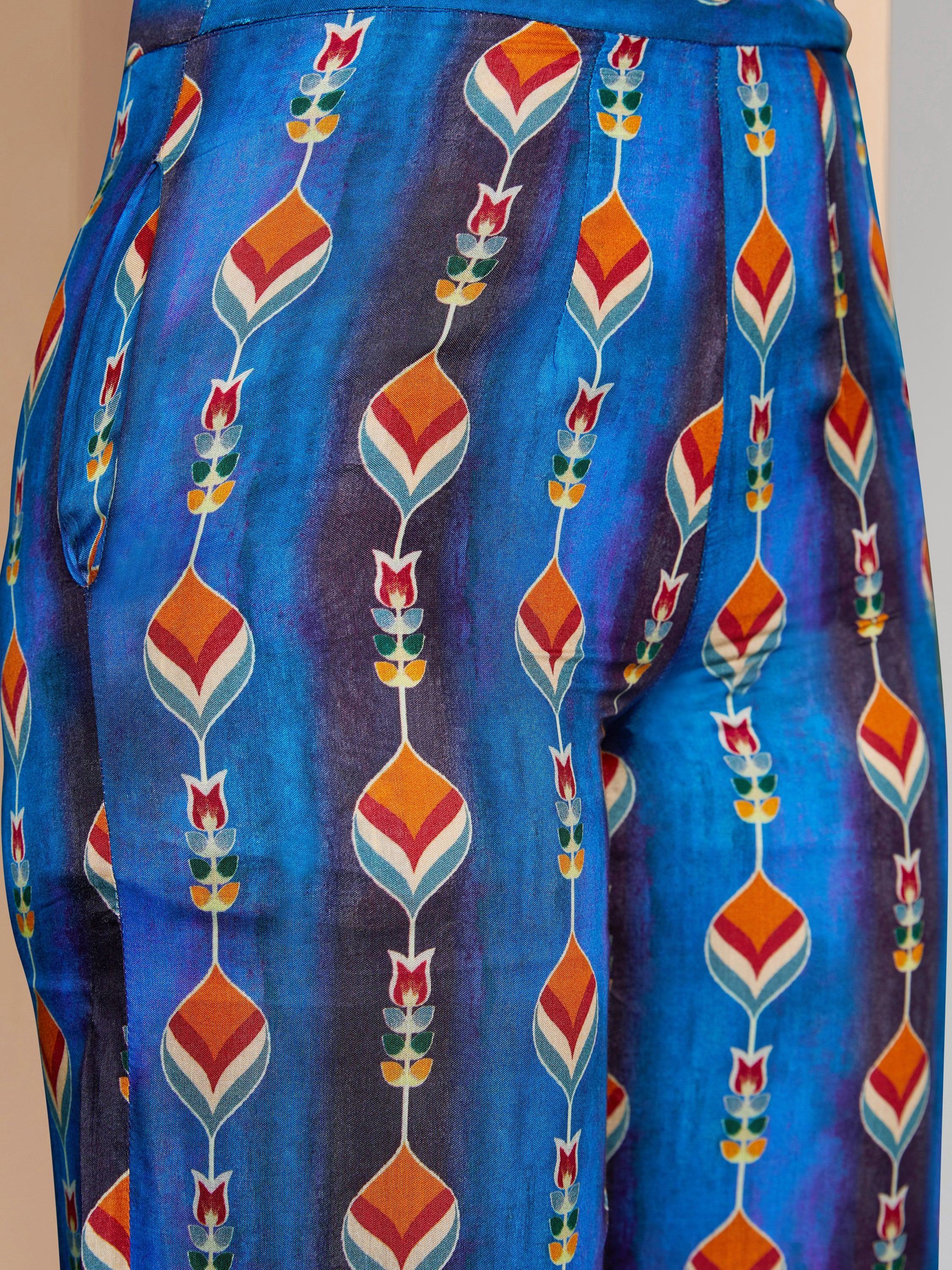 Close-up of blue ethnic print salwar with orange and yellow floral patterns