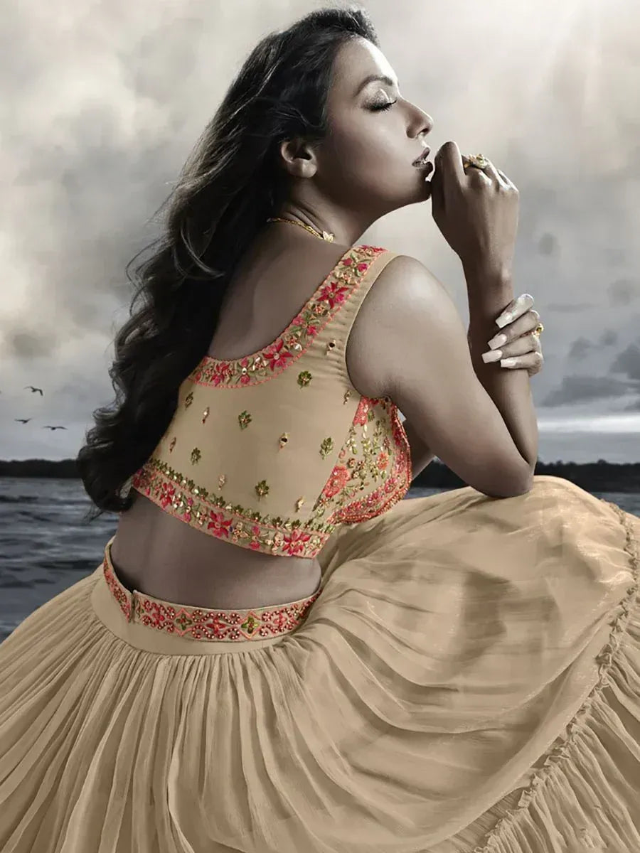 Beige embroidered lehenga choli with floral detailing, perfect for Indian ethnic wear occasions.