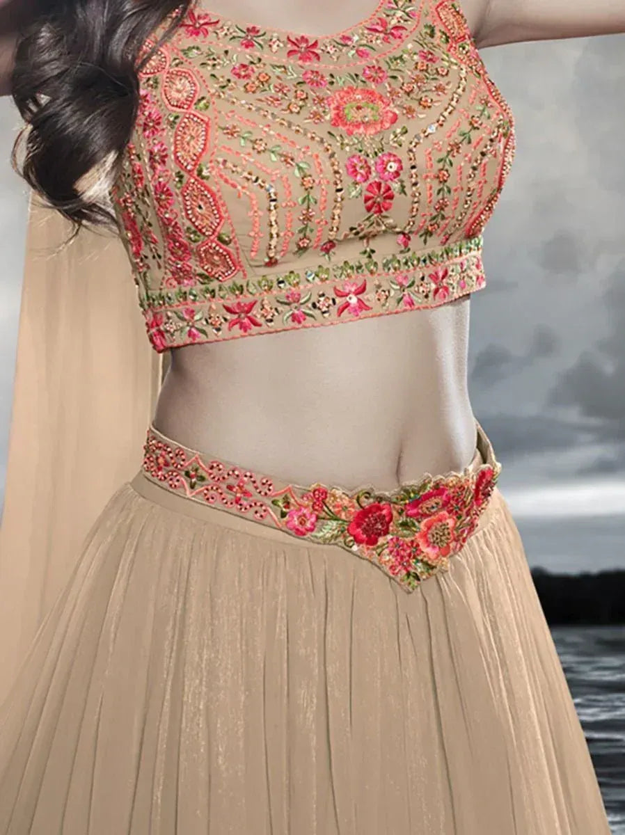 Beige lehenga choli with pink floral embroidery, perfect for Indian ethnic wear events