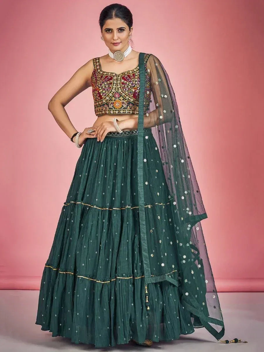 Emerald green lehenga choli with embroidered blouse and sheer dupatta, perfect for Indian ethnic occasions.