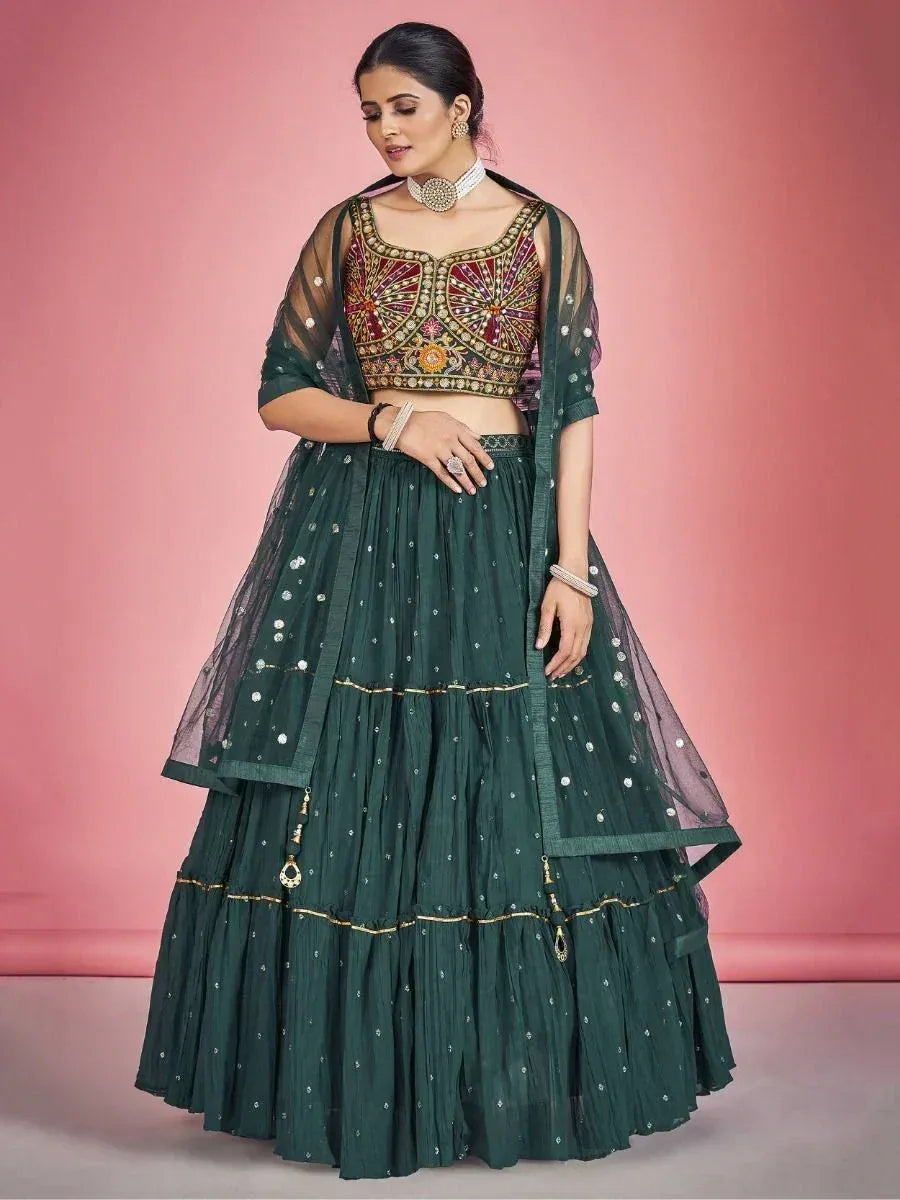 Emerald green designer lehenga choli with heavy embroidery and sheer dupatta, perfect for Indian weddings and festive occasions.
