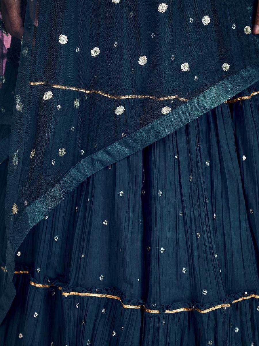 Navy blue ethnic lehenga with gold embroidery and sheer dupatta, perfect for Indian weddings and festive occasions.