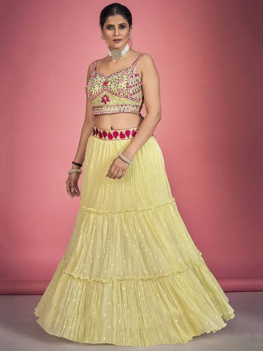 Yellow embroidered lehenga choli with floral top and tiered skirt, perfect for Indian ethnic wear occasions