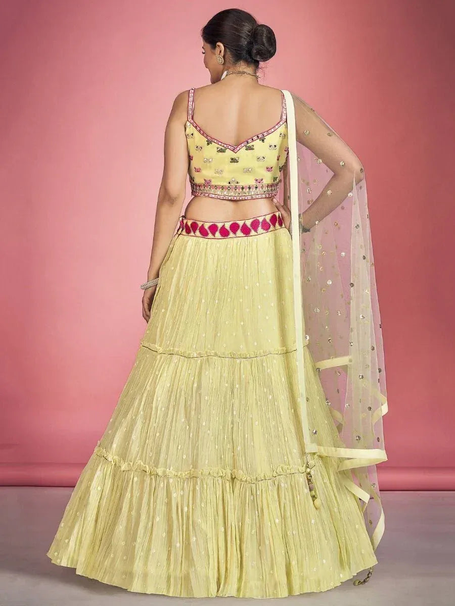 Yellow lehenga choli with pink embroidery and sheer dupatta, ethnic Indian wear for women