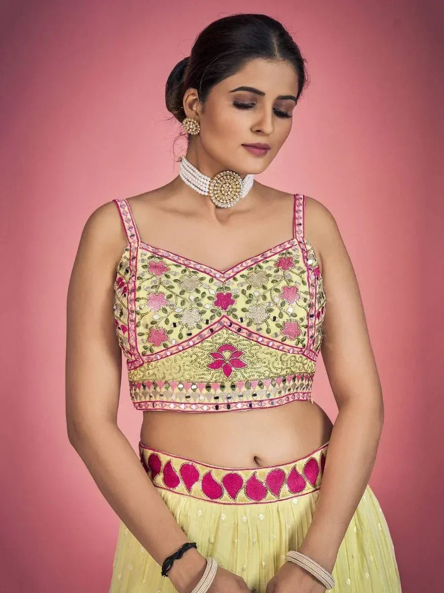 Yellow floral embroidered lehenga choli with pink detailing, perfect for Indian ethnic wear occasions
