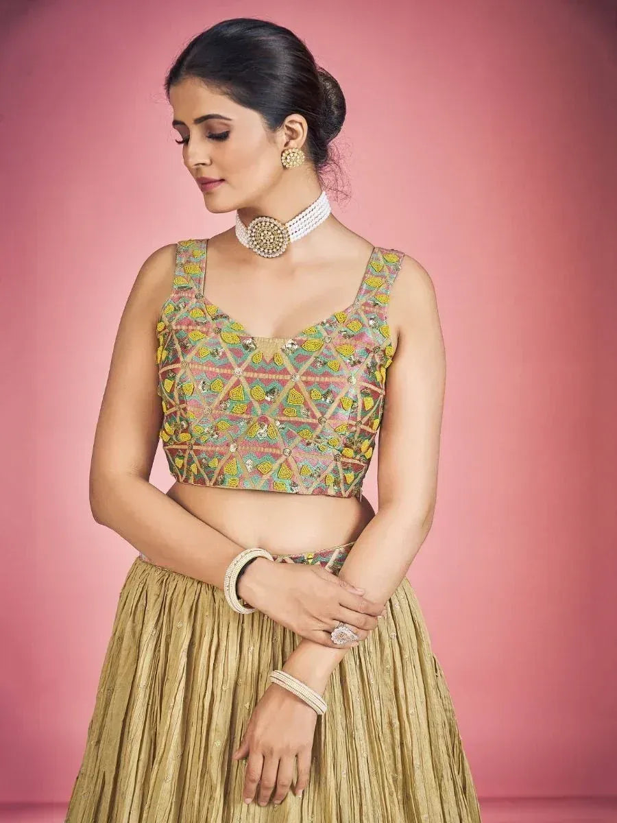 Designer lehenga choli with colorful embroidered blouse and gold pleated skirt, perfect for Indian ethnic wear.