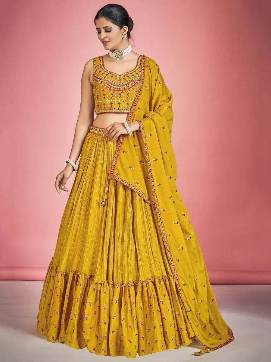 Yellow embroidered lehenga choli with floral motifs, perfect for Indian ethnic occasions
