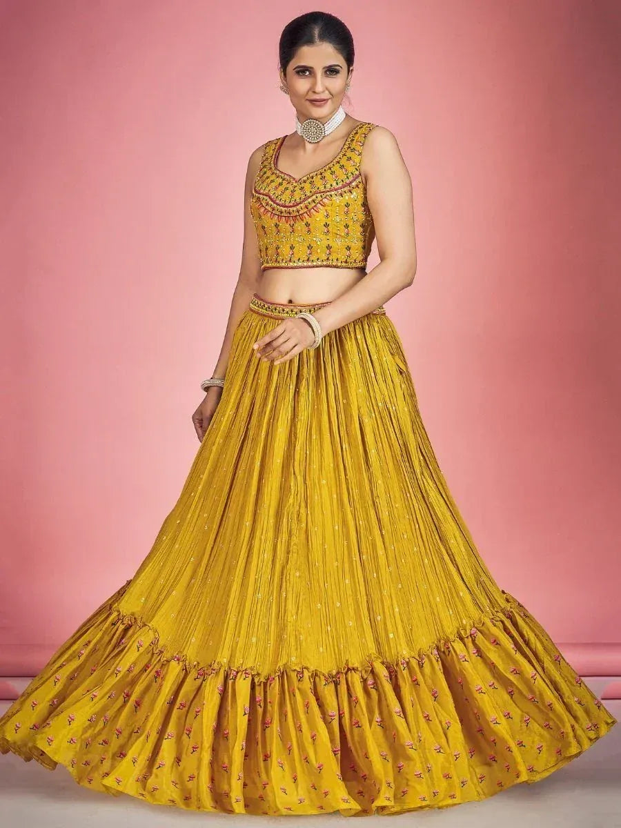 Yellow embroidered lehenga choli with floral border, perfect for Indian ethnic wear occasions