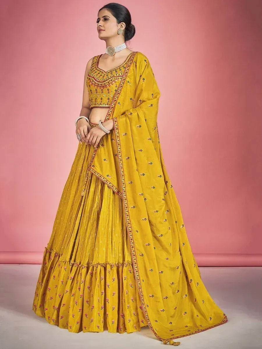 Yellow embroidered lehenga choli with floral motifs, perfect for Indian ethnic occasions