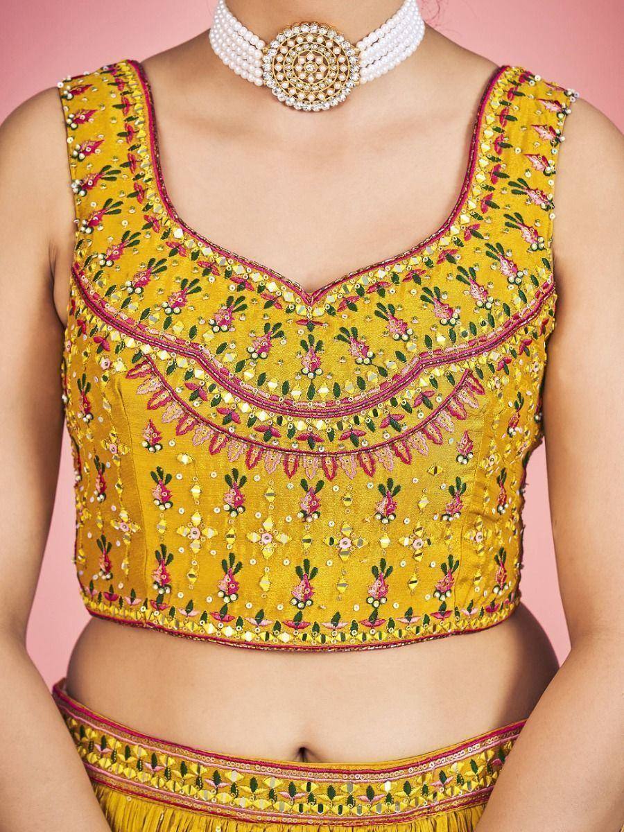 Yellow embroidered lehenga choli top with floral mirror work and pearl choker necklace