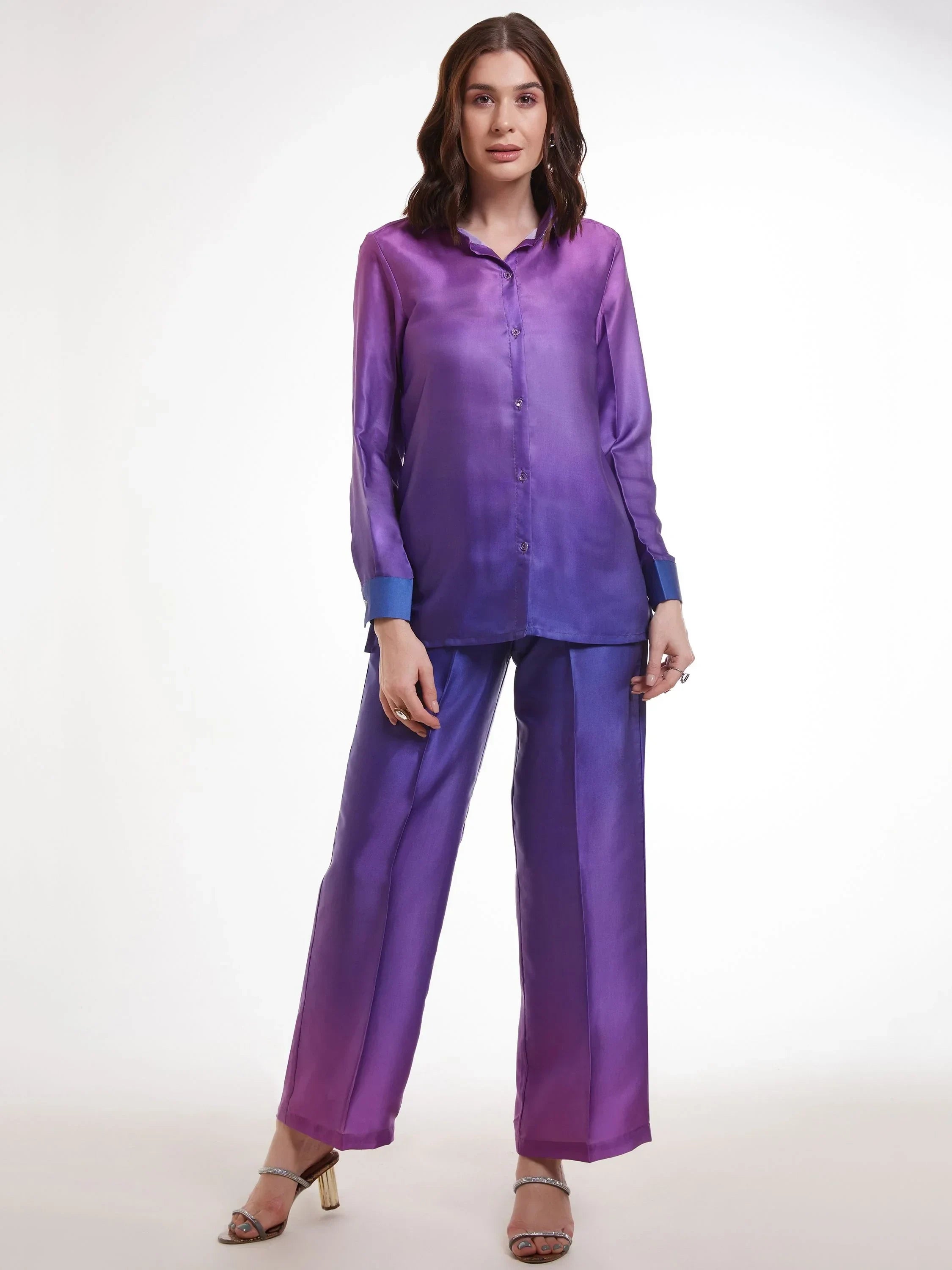 Woman in purple satin shirt and wide-leg pants set, modern ethnic wear, white background.
