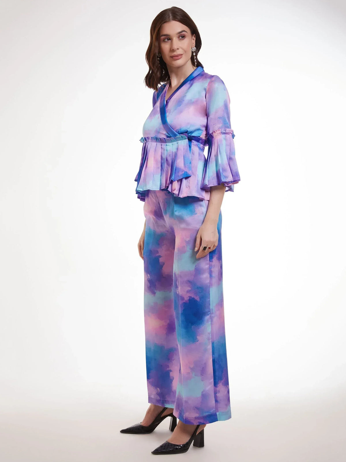 Woman in purple blue tie-dye ethnic palazzo set with ruffled wrap top, perfect for Indian occasions.