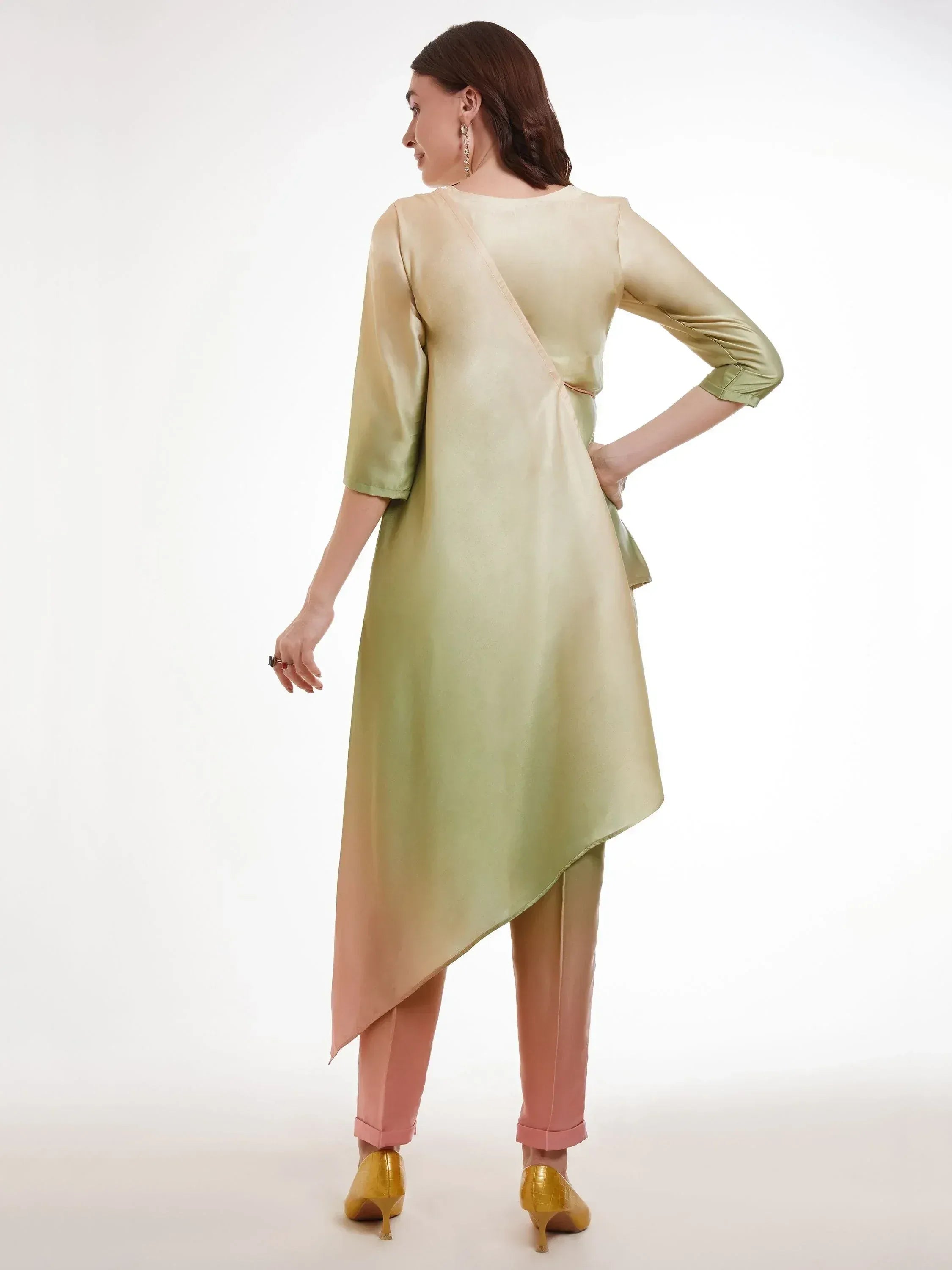 Woman in pastel green asymmetrical kurti and pink pants, back view, ethnic wear fashion