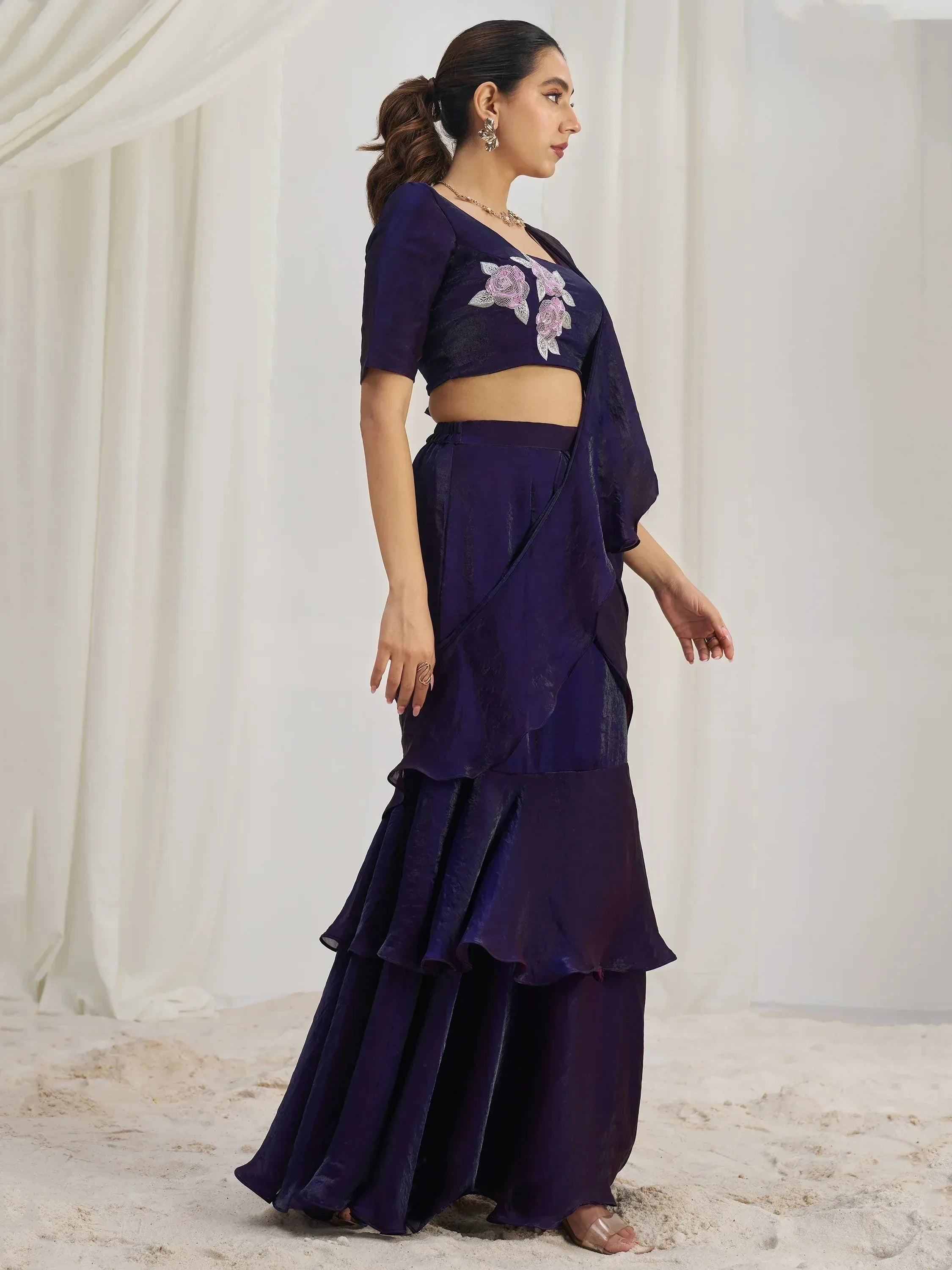 Elegant purple ruffled lehenga choli with floral embroidery, perfect for Indian ethnic wear.