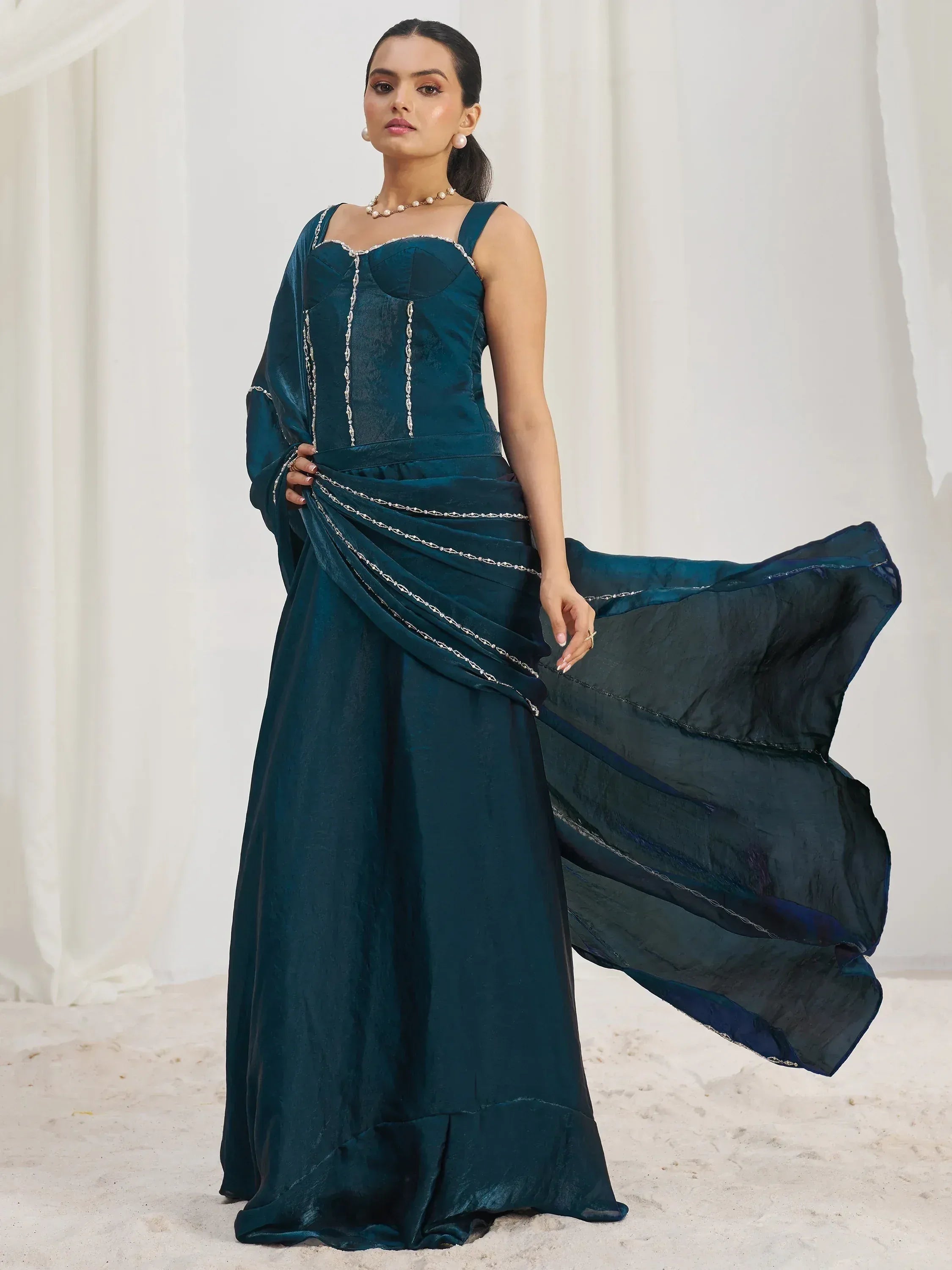 Elegant teal ethnic gown with silver embroidery, perfect for Indian celebrations and events.