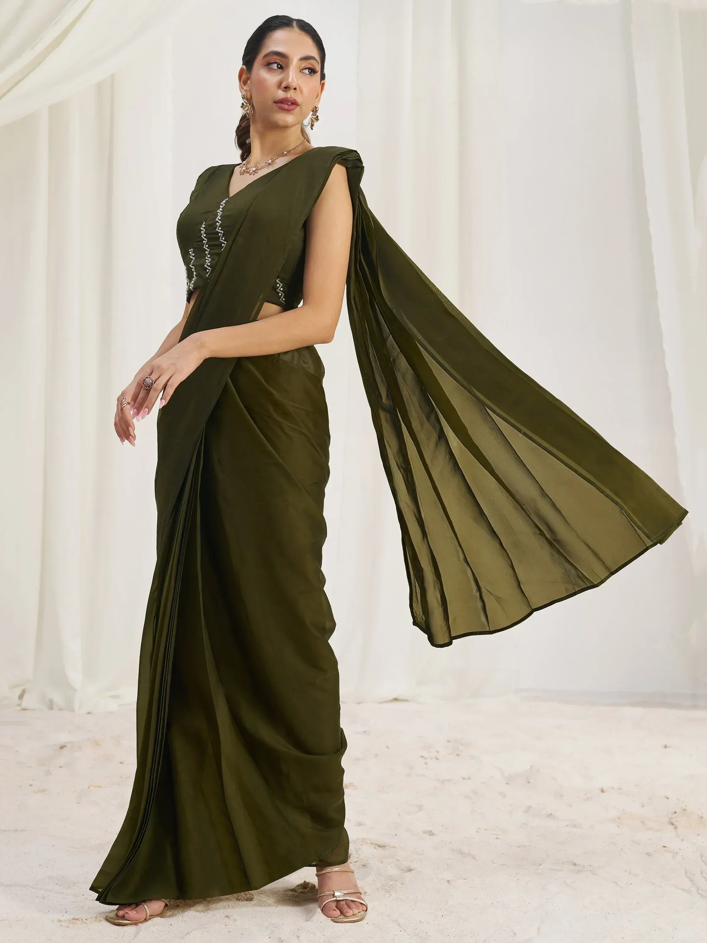 Olive green saree with embroidered blouse, elegant drape, and stylish accessories for Indian ethnic wear