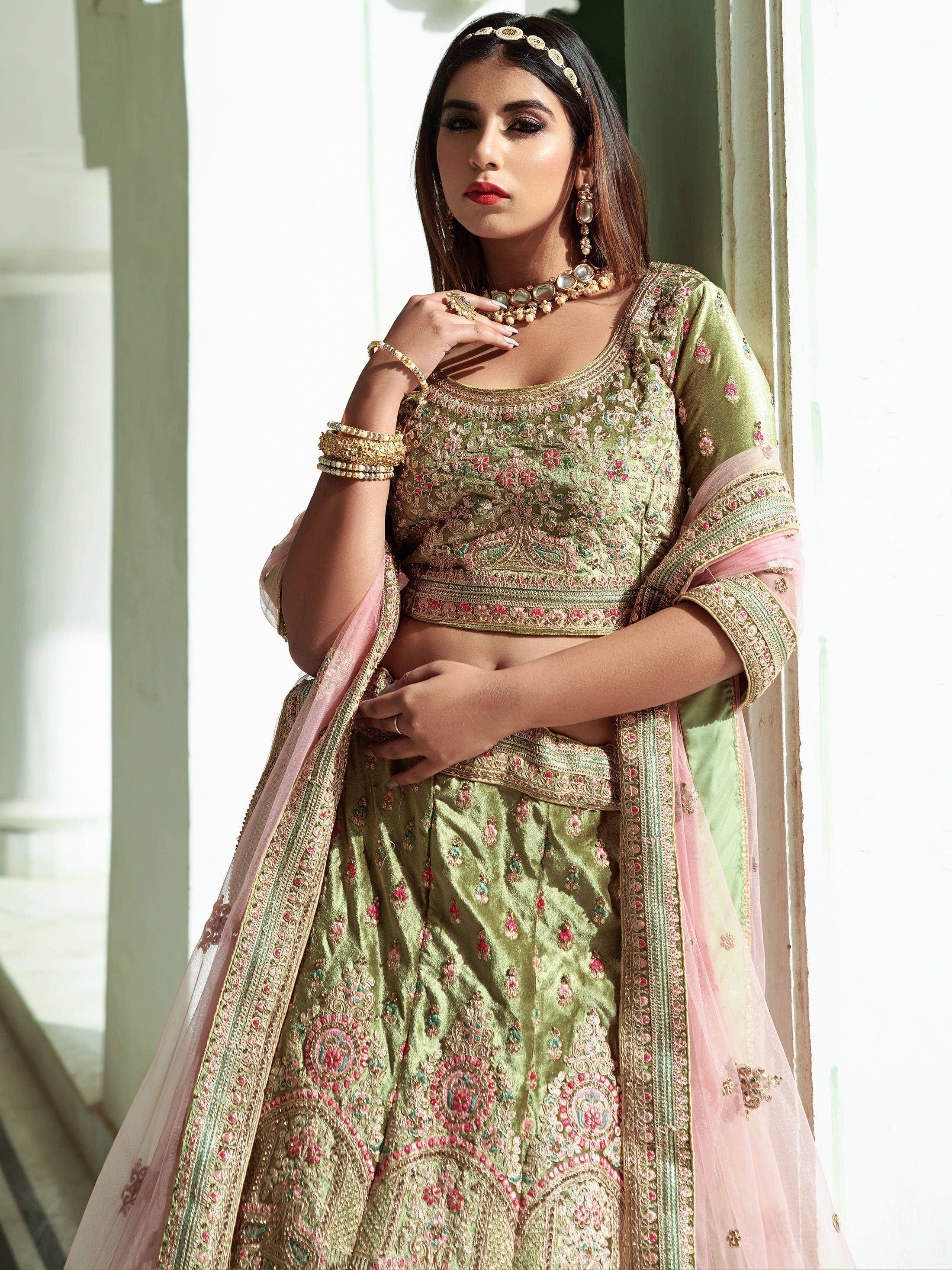 Elegant green embroidered lehenga choli with pink dupatta, perfect for Indian weddings and festive occasions.