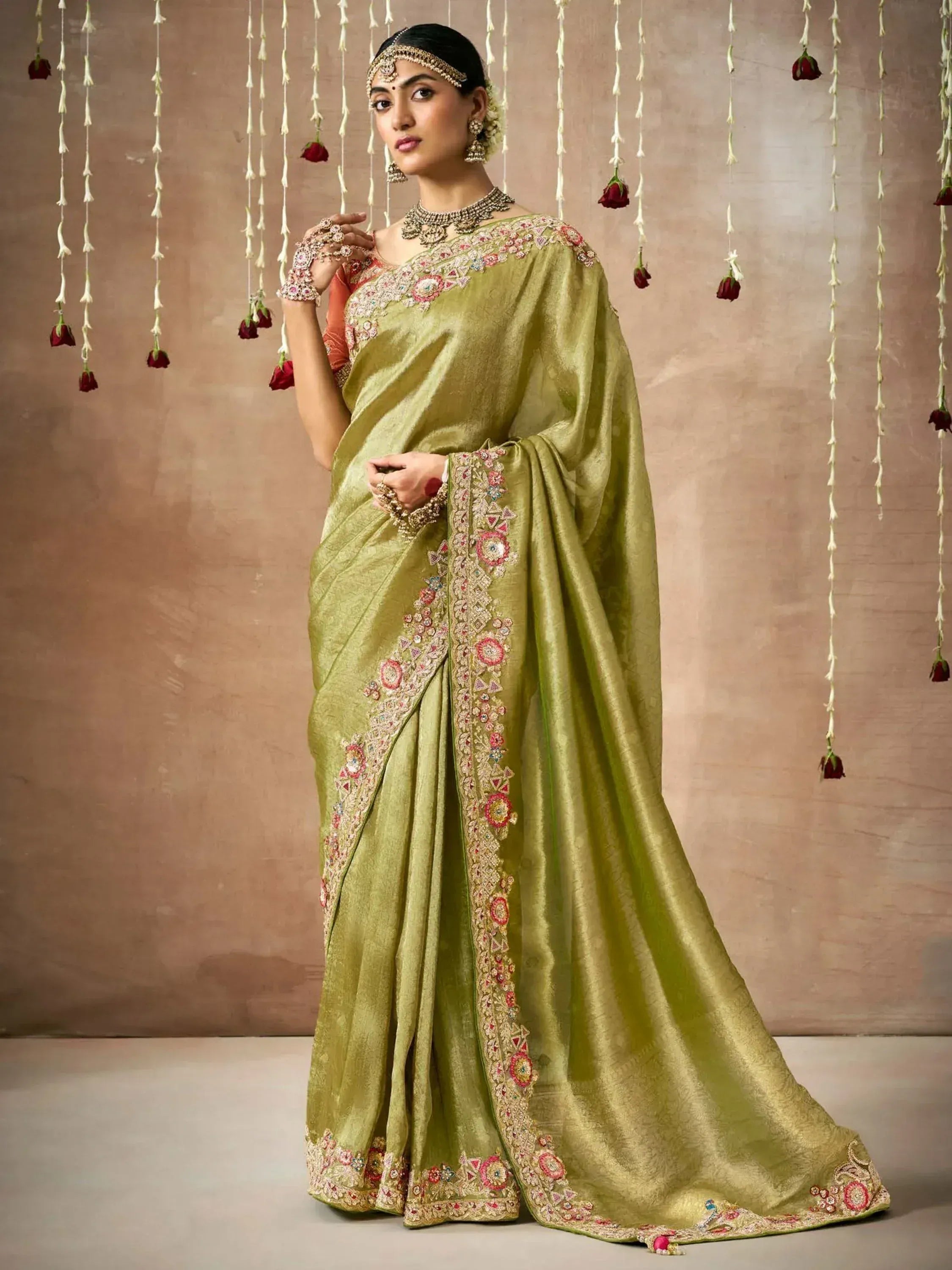 Olive green embroidered saree with floral motifs, perfect for Indian ethnic occasions and weddings.