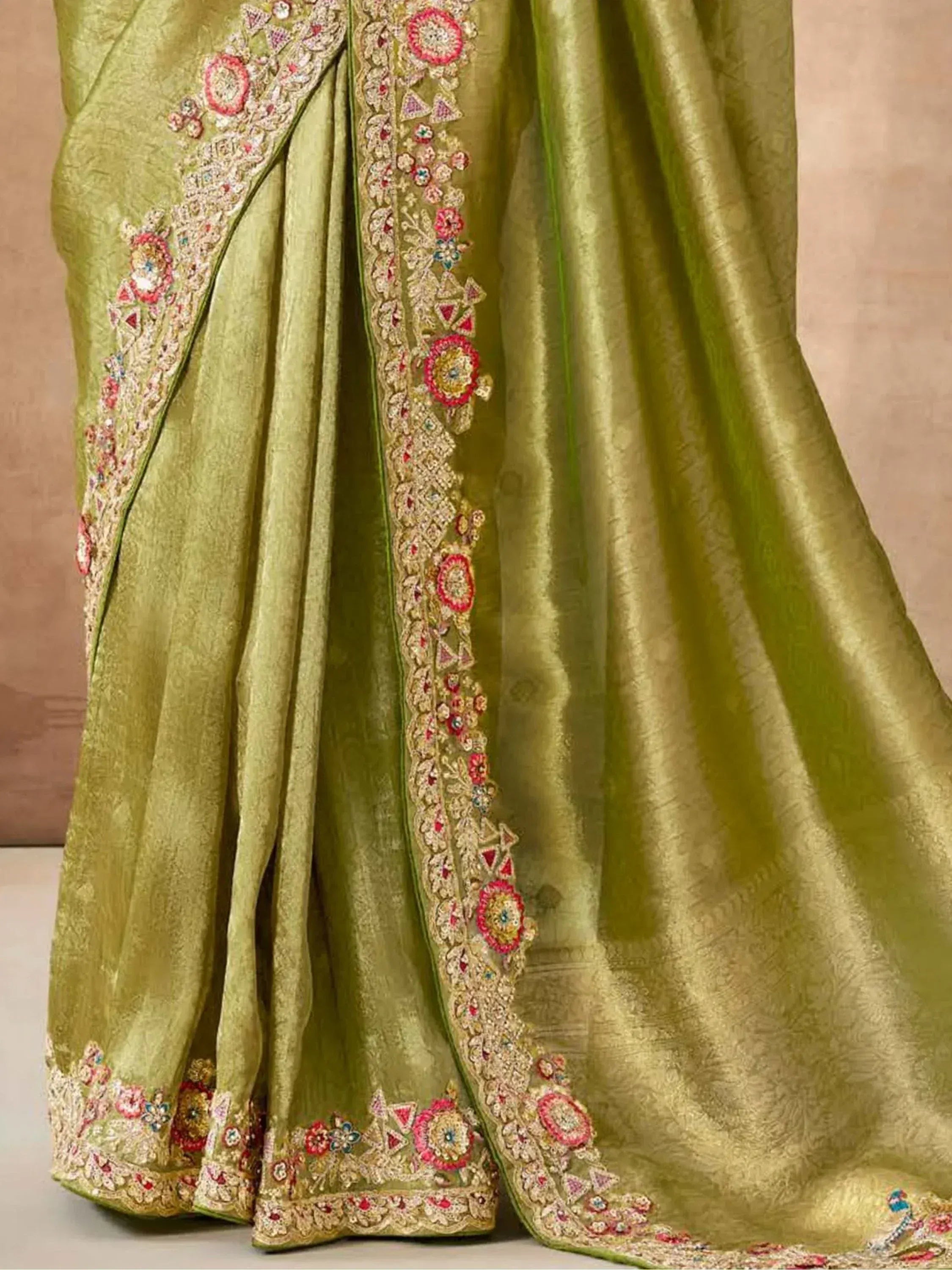Olive green designer saree with intricate floral embroidery and zari work, perfect for Indian ethnic occasions.