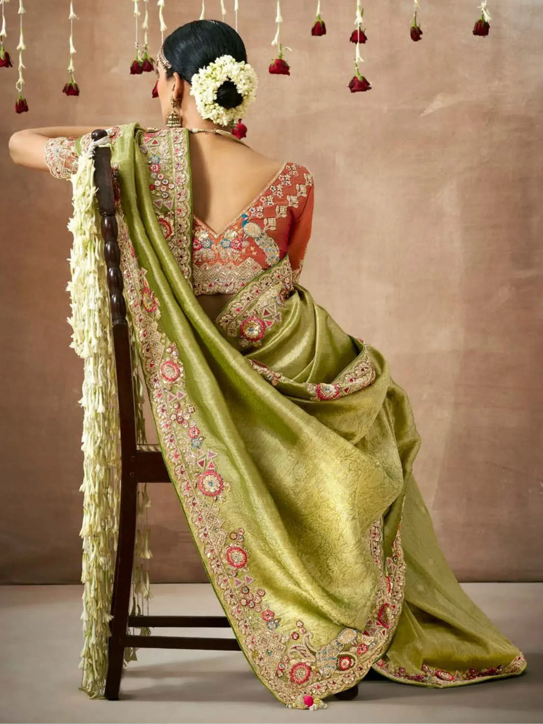 Elegant green embroidered saree with floral border, paired with a designer blouse, perfect for Indian ethnic wear.