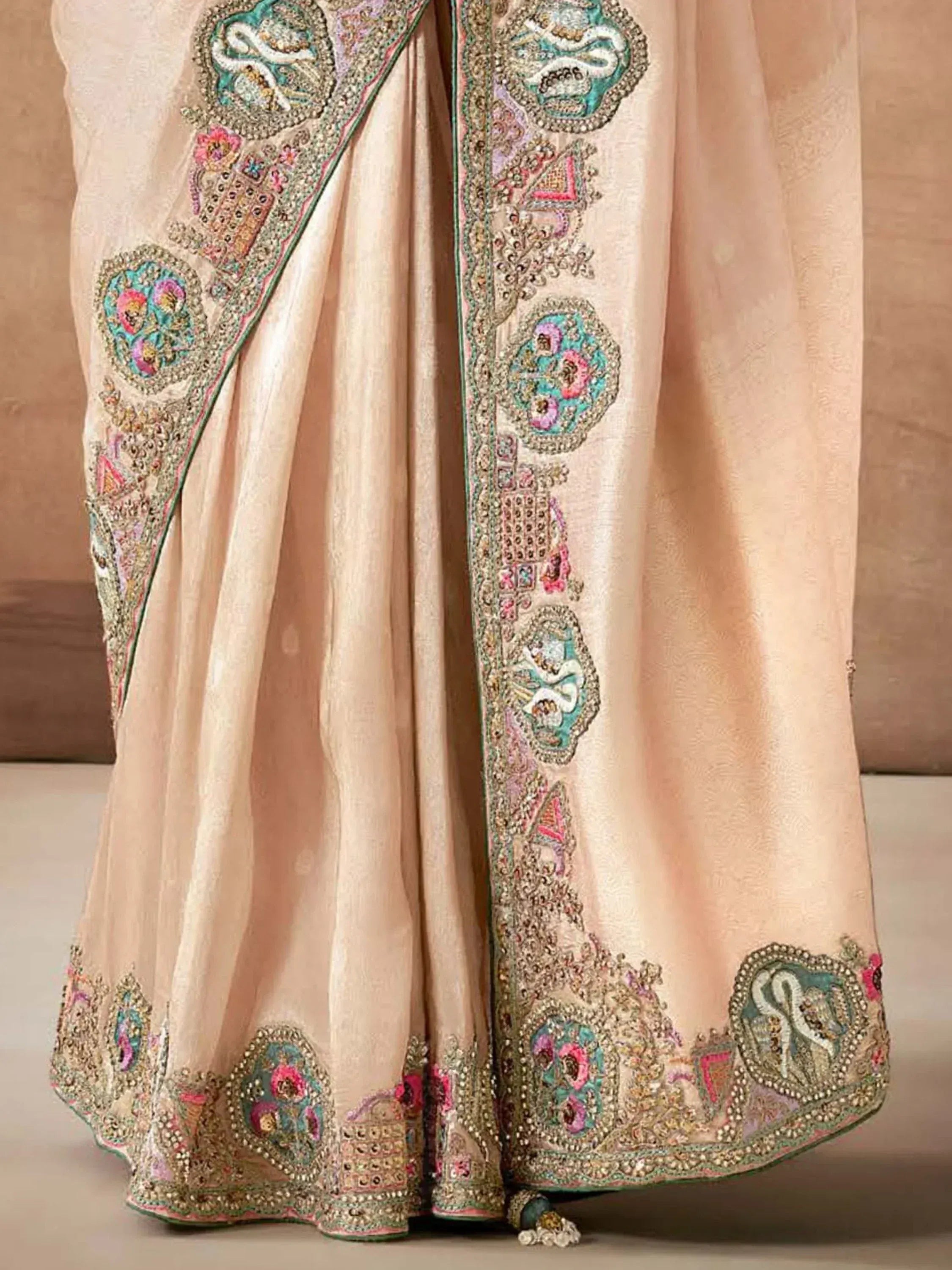 Beige designer lehenga with intricate floral embroidery and embellished border for Indian ethnic wear