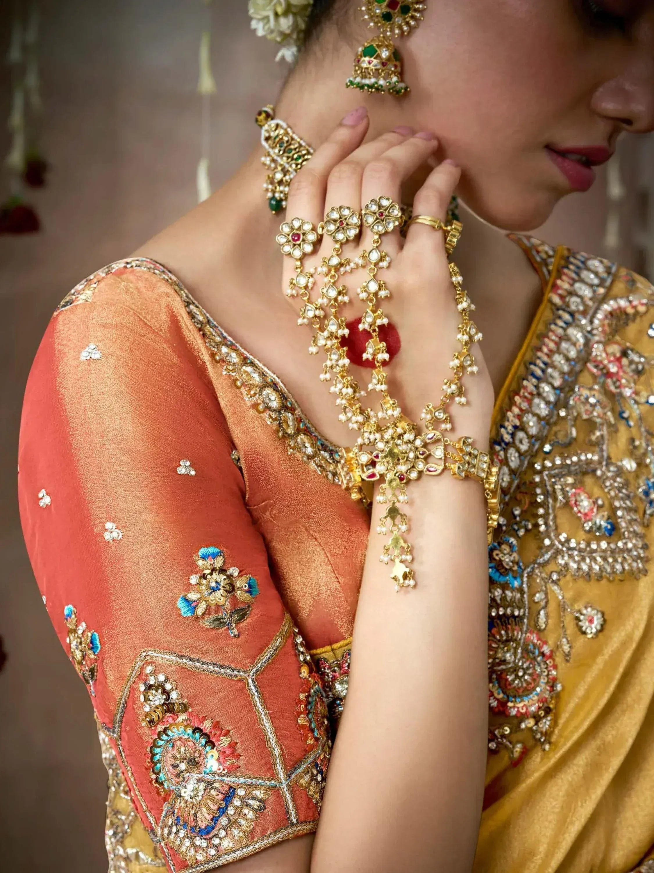 Elegant Indian bridal lehenga choli with heavy gold jewelry and floral embroidery