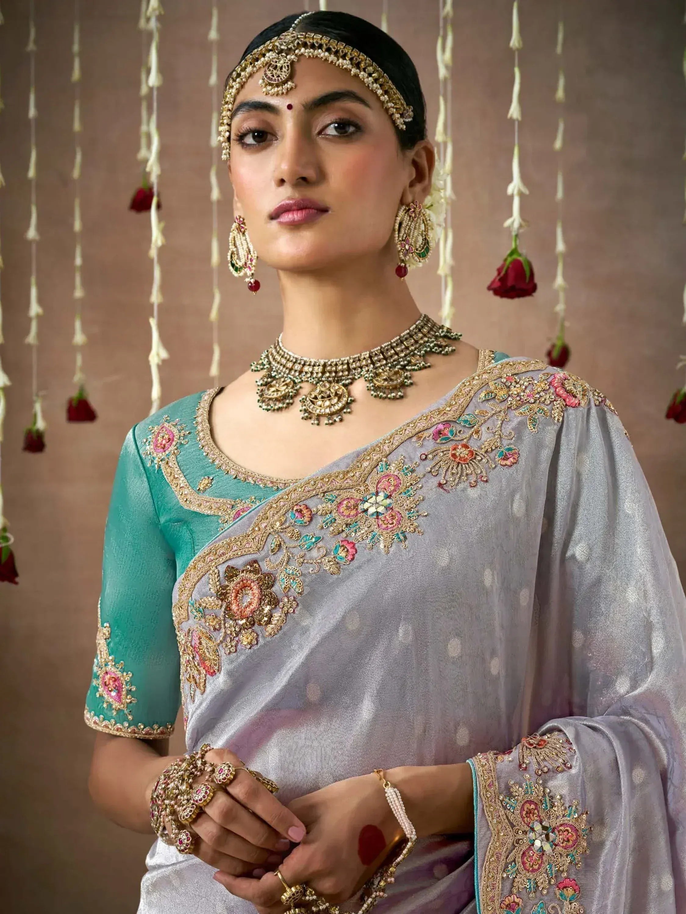 Elegant grey and teal embroidered saree with gold jewelry, perfect for Indian ethnic occasions