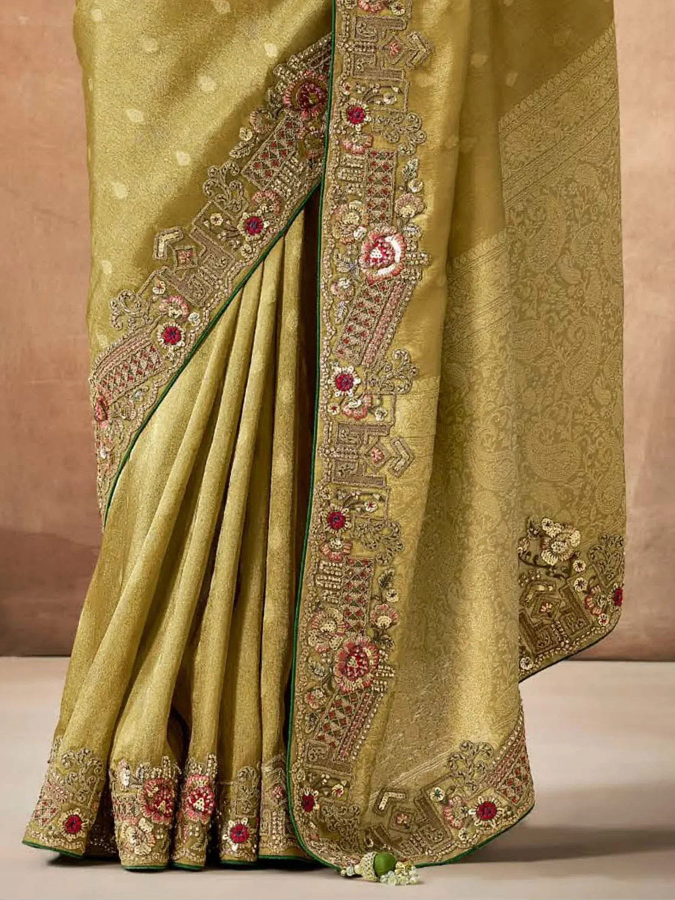 Olive green designer saree with intricate floral embroidery and zari work, perfect for ethnic occasions.