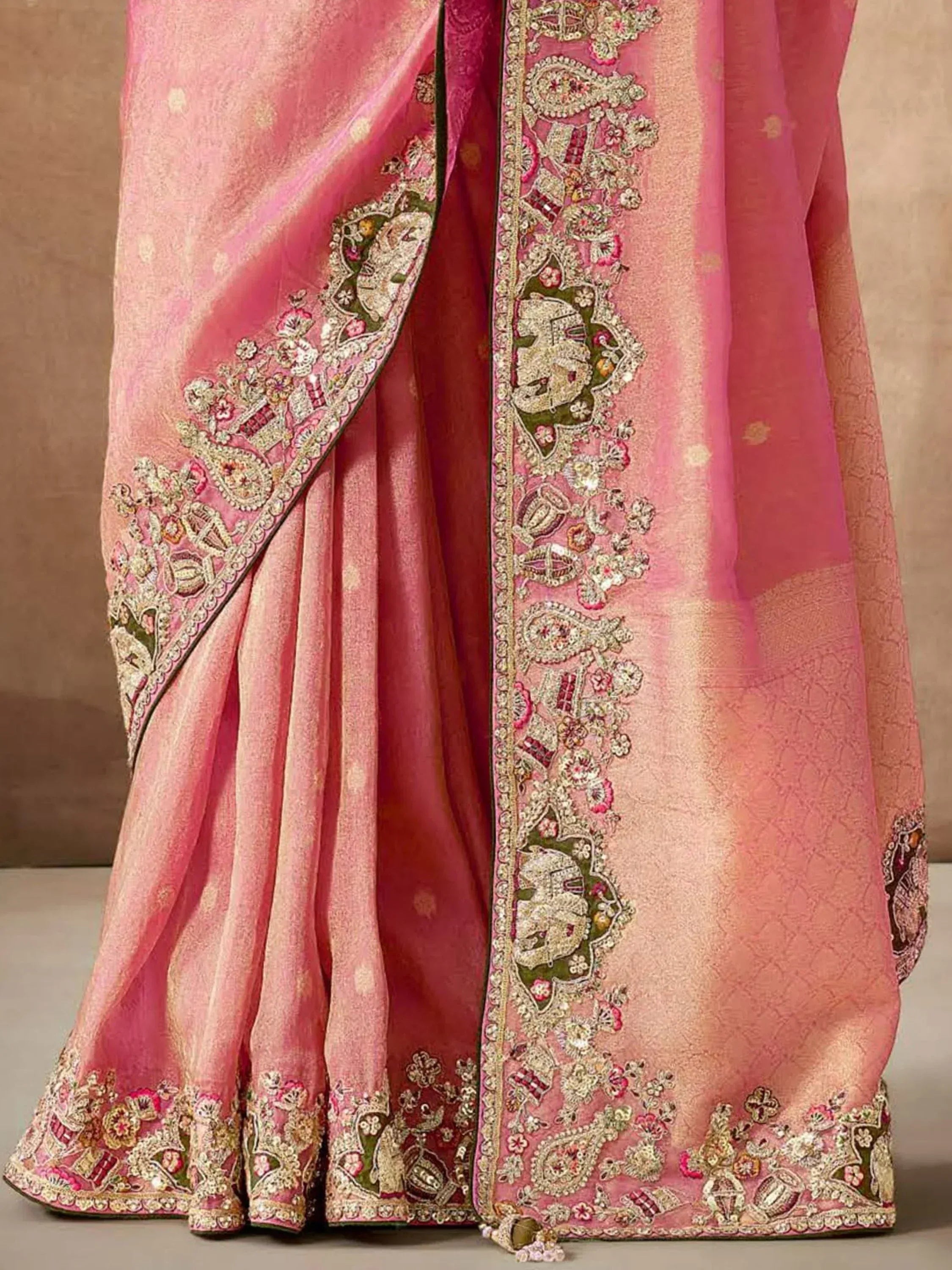 Pink designer saree with intricate gold embroidery and floral motifs, perfect for Indian ethnic wear
