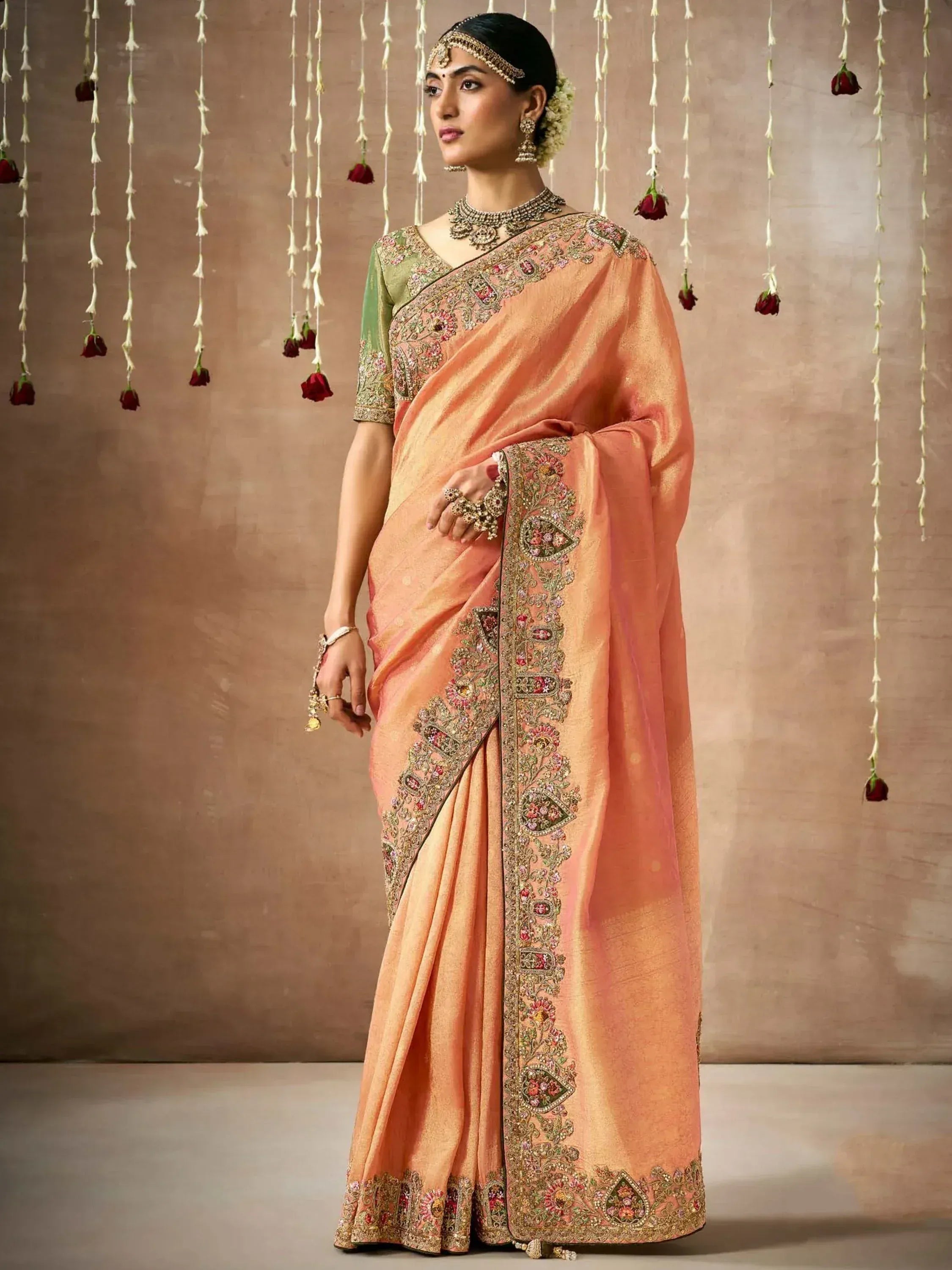 Peach embroidered saree with green blouse, perfect for Indian ethnic wear and festive occasions.