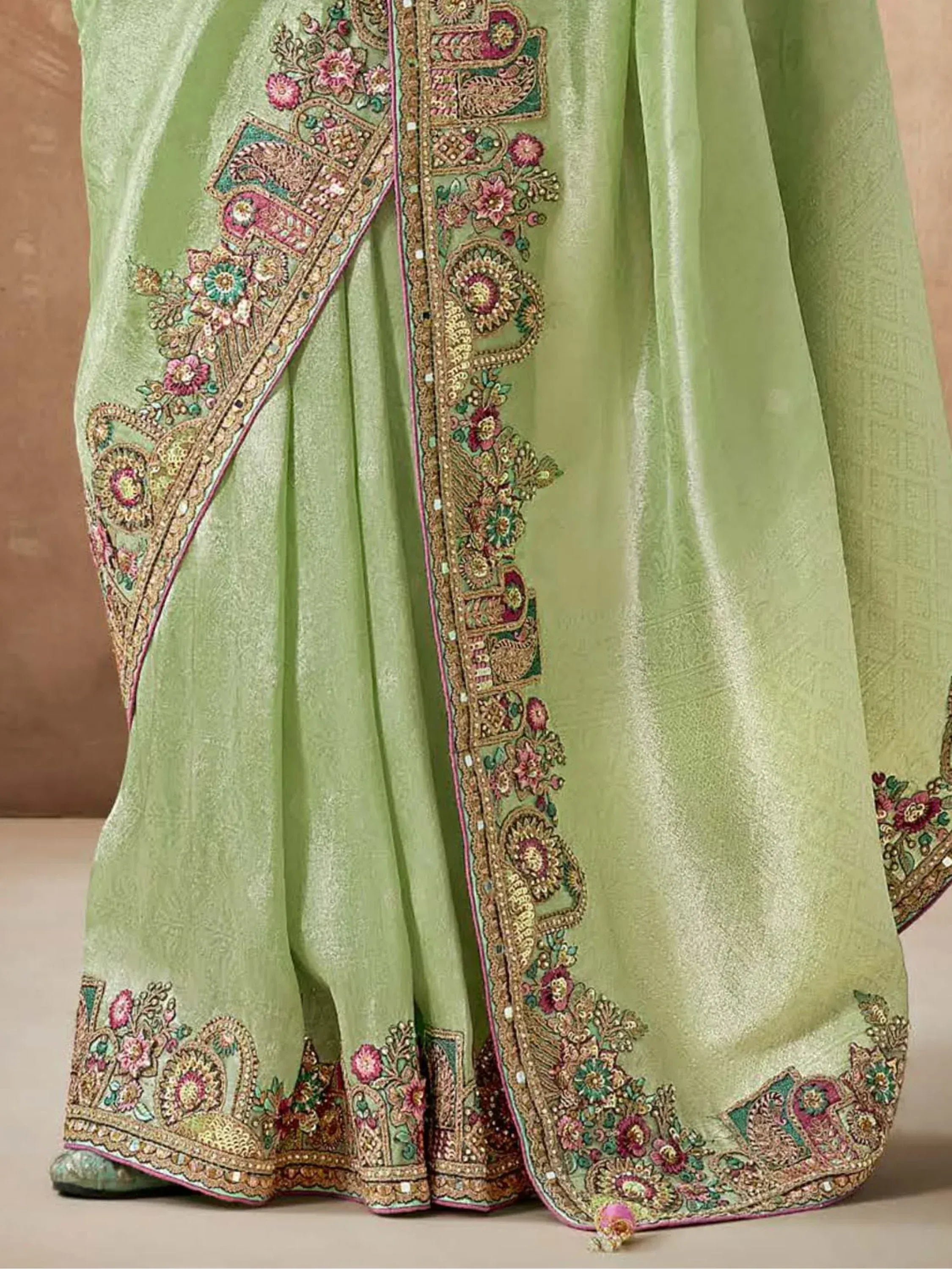 Light green ethnic saree with intricate floral and paisley embroidery, perfect for Indian occasions.