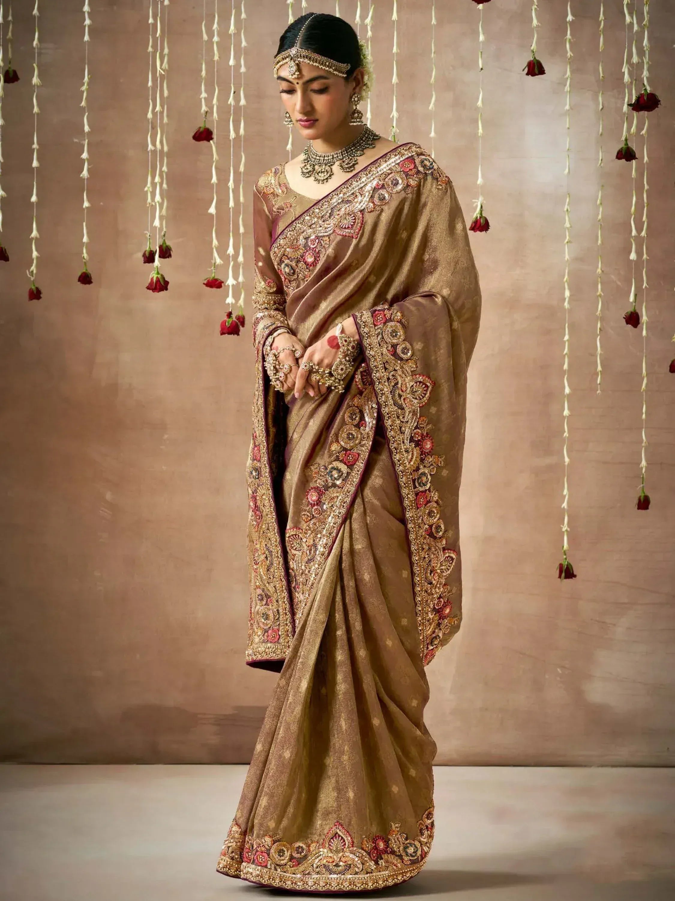 Elegant gold embroidered saree with floral motifs, perfect for Indian weddings and festive occasions.