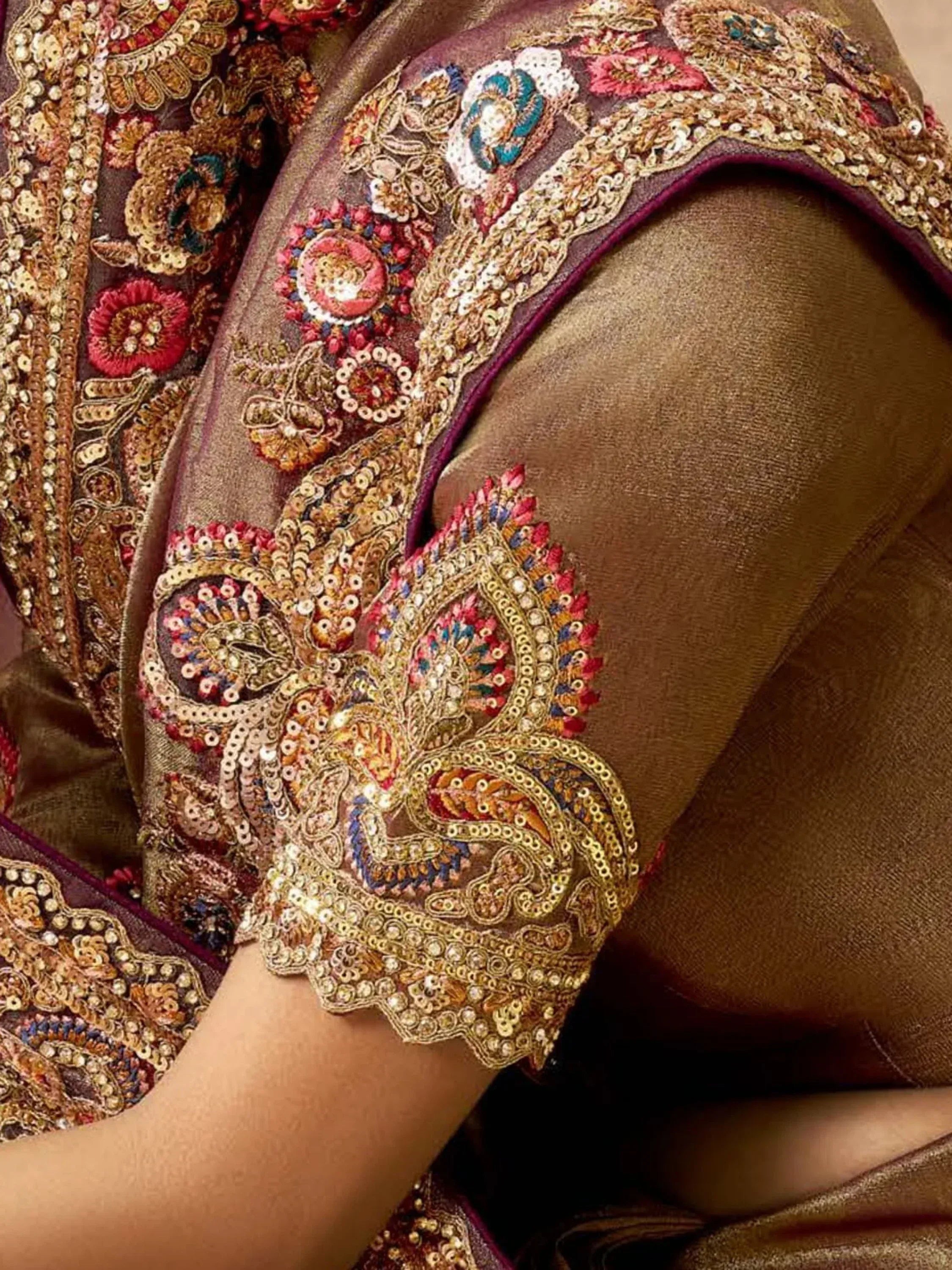 Richly embroidered Indian ethnic wear with floral and paisley sequin details on velvet fabric.