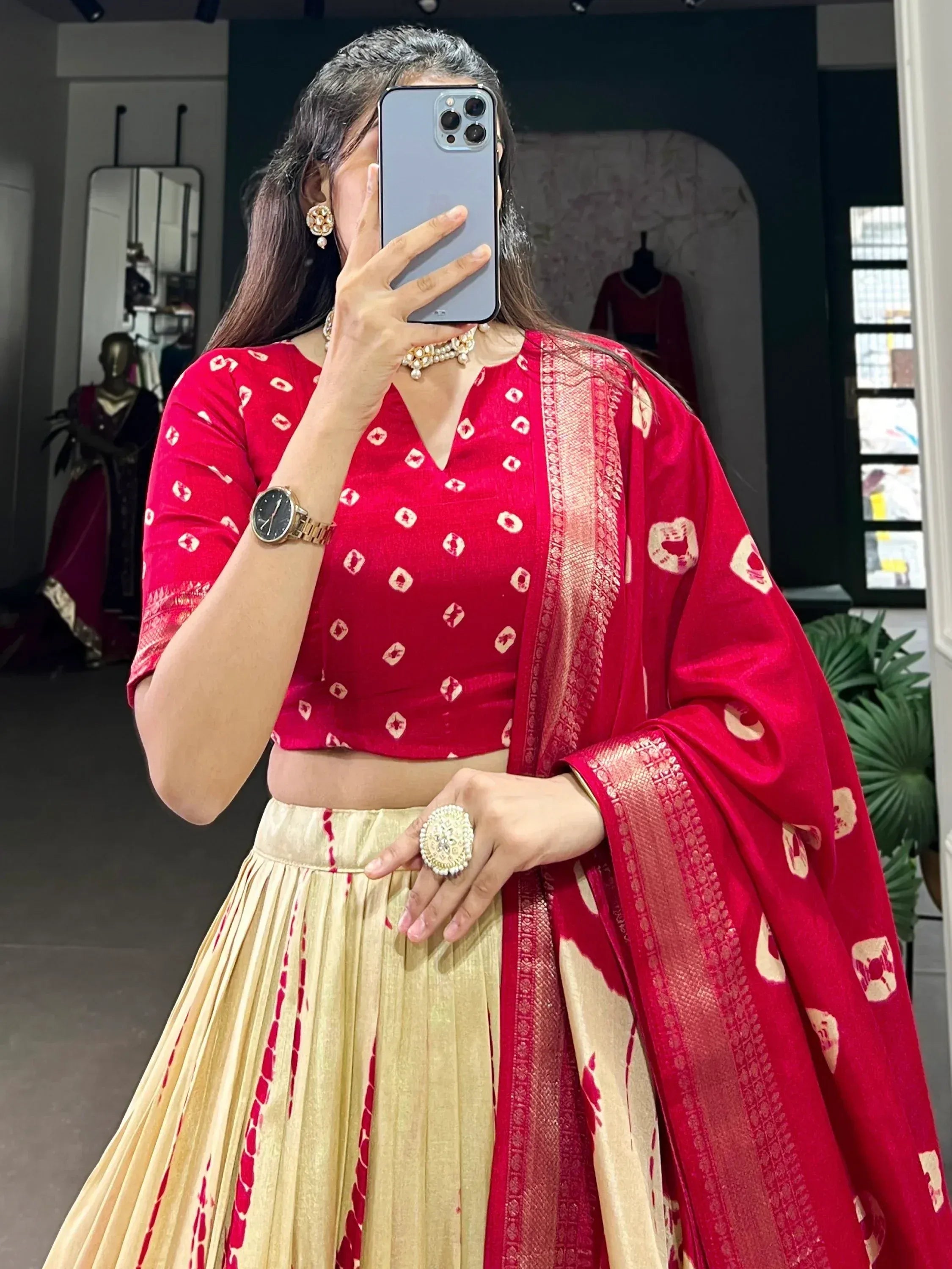 Red and gold ethnic lehenga choli with printed blouse and dupatta, perfect for festive occasions