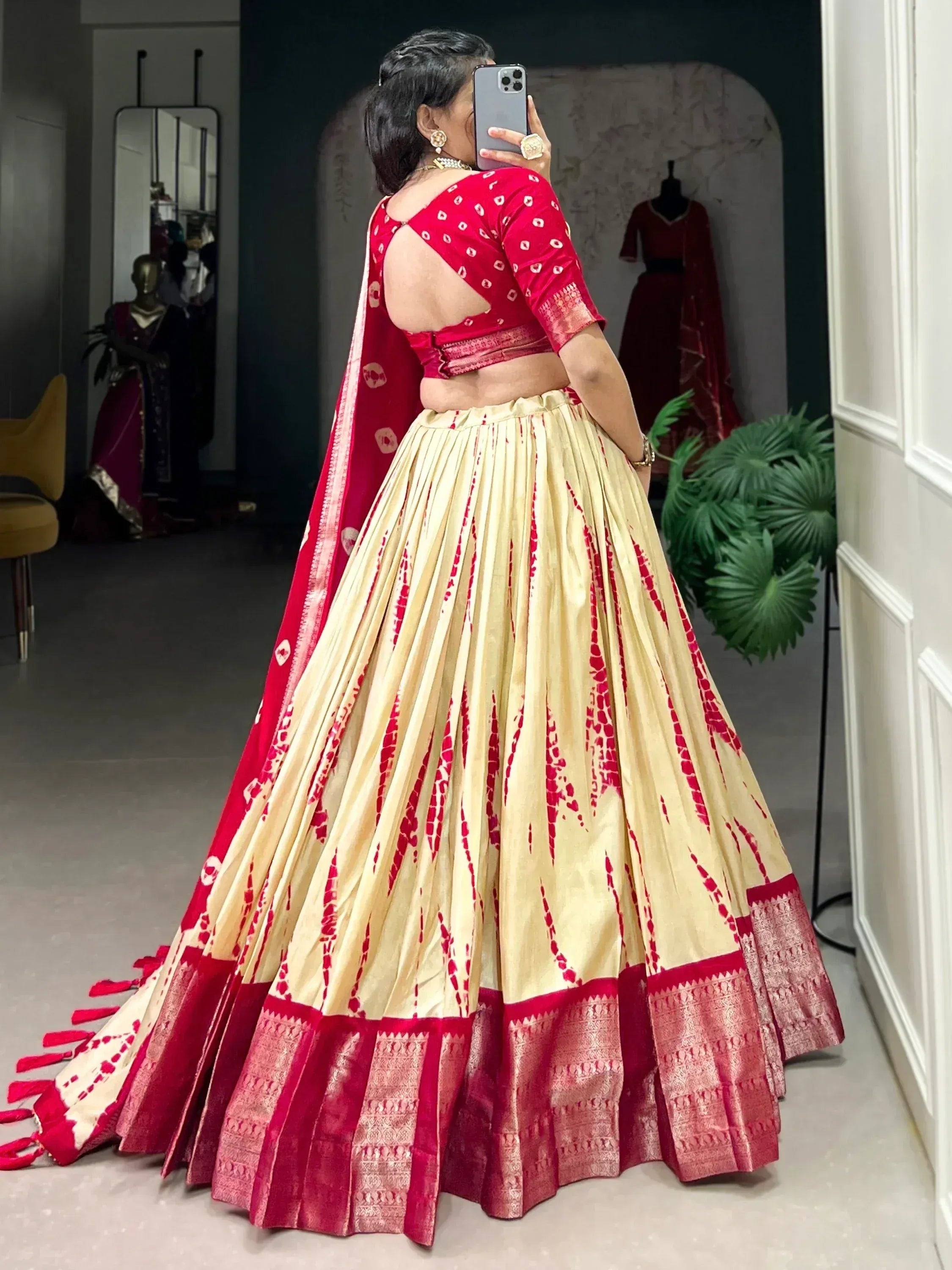 Red and cream designer lehenga choli with backless blouse, perfect for Indian weddings and festive occasions