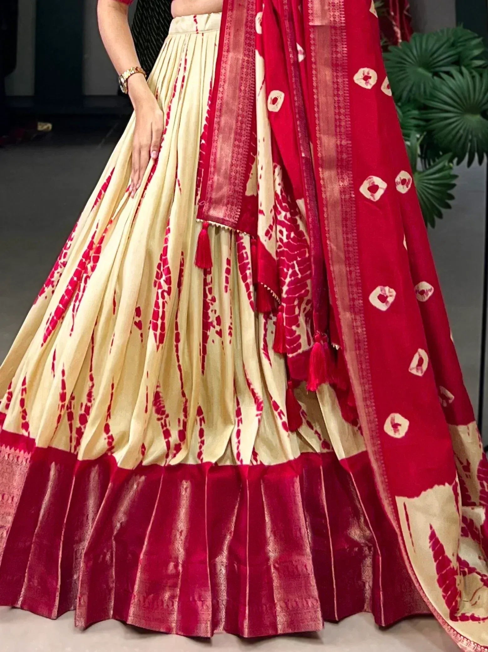 Cream and red tie-dye lehenga choli with velvet border and matching dupatta, ethnic Indian wear