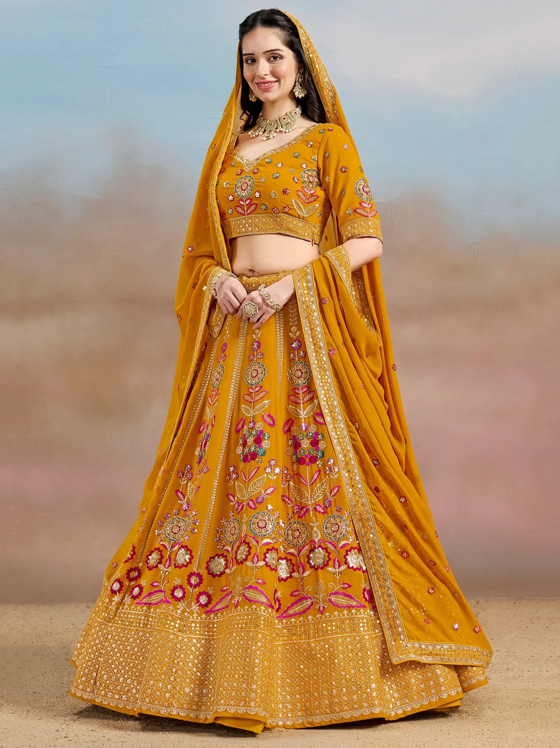 Mustard yellow embroidered lehenga choli with floral motifs and dupatta, perfect for Indian weddings and festive occasions.