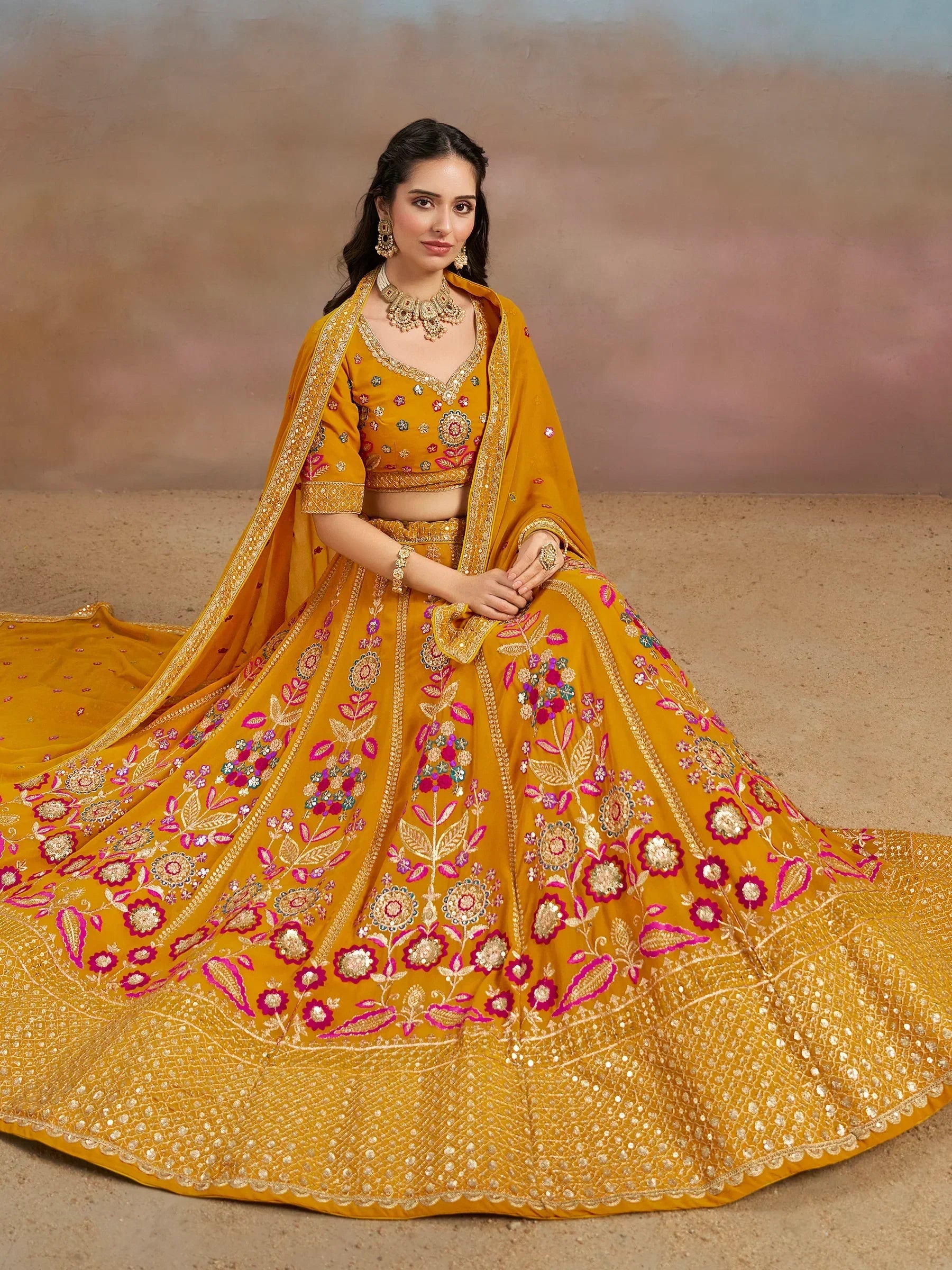 Mustard yellow designer lehenga choli with floral embroidery and gold detailing, perfect for weddings and festive occasions.