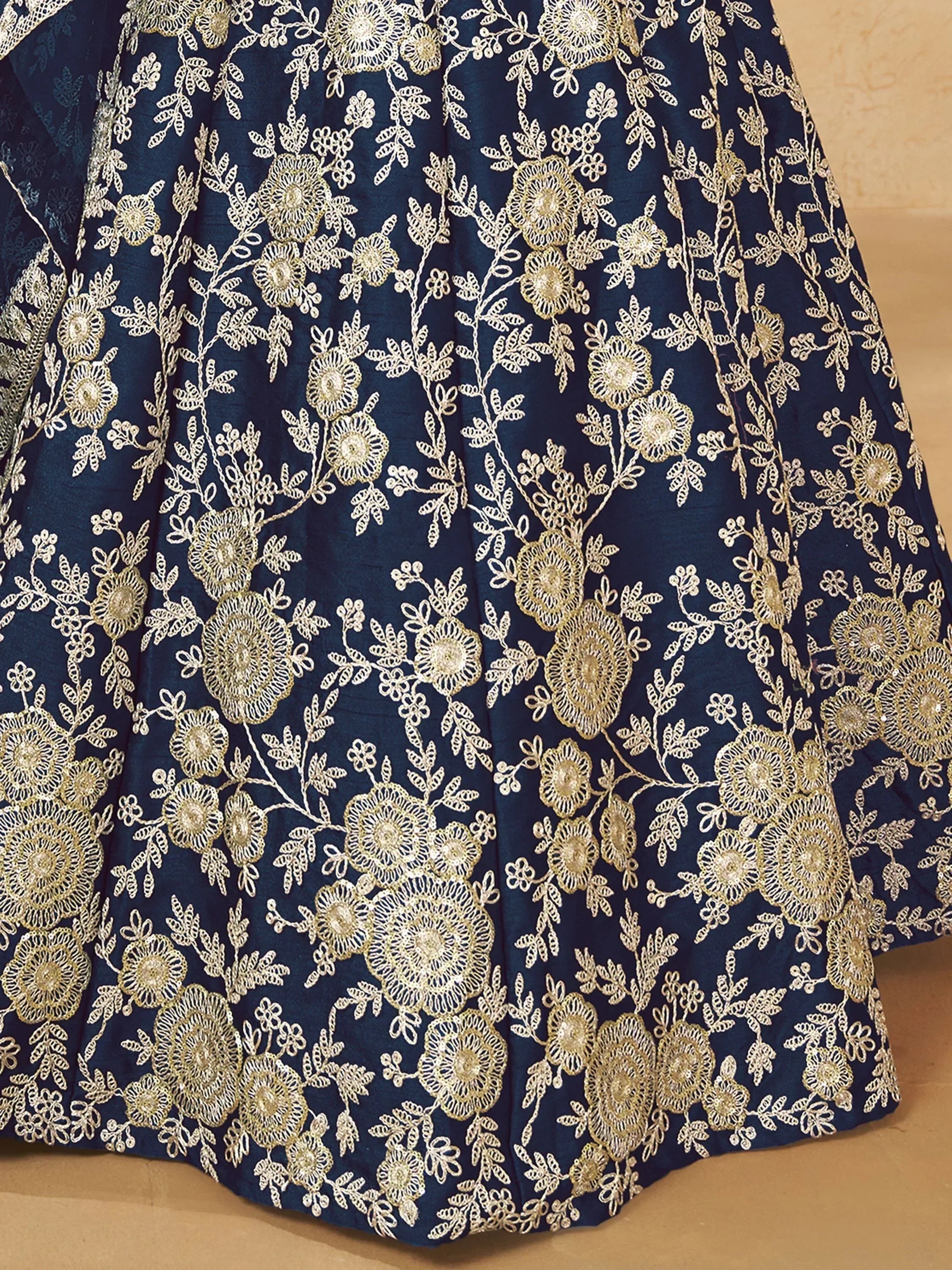 Navy blue lehenga skirt with intricate gold floral embroidery, perfect for Indian ethnic wear.