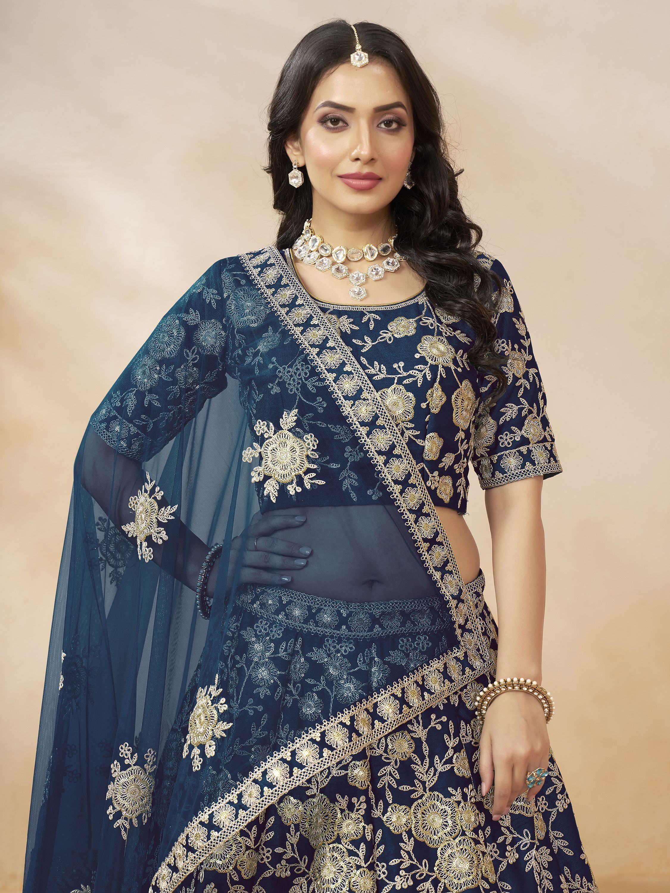 Navy blue designer lehenga choli with gold floral embroidery and sheer dupatta, perfect for Indian ethnic wear