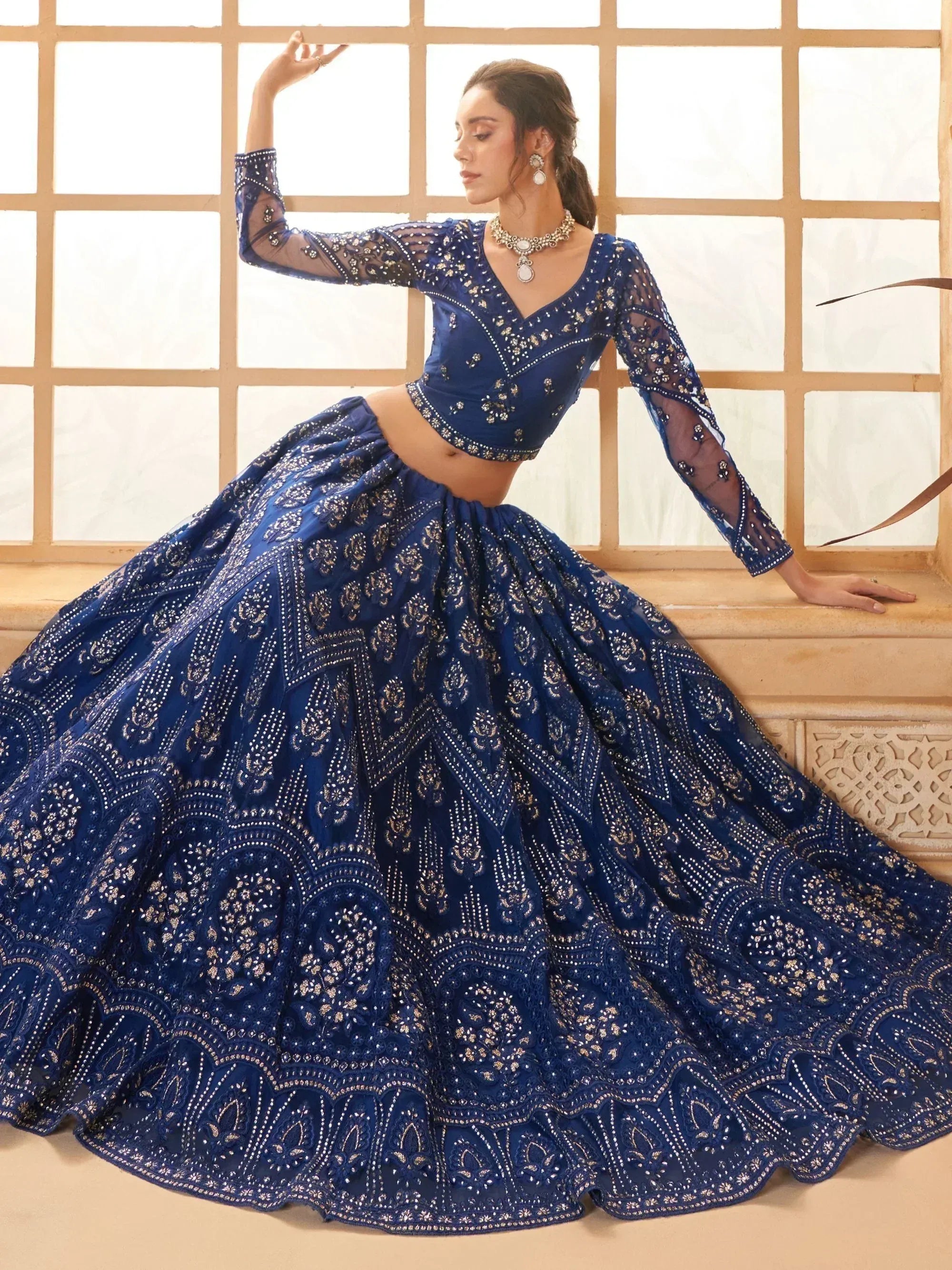 Royal blue embroidered lehenga choli with sheer sleeves, perfect for Indian weddings and festive occasions.
