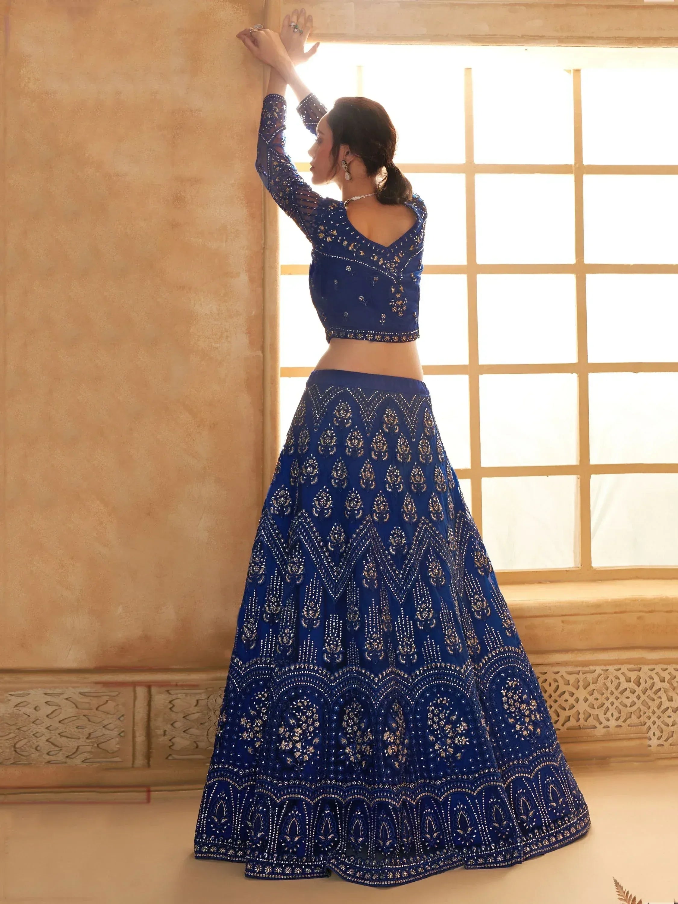 Royal blue embroidered lehenga choli with gold detailing, perfect for Indian weddings and festive occasions