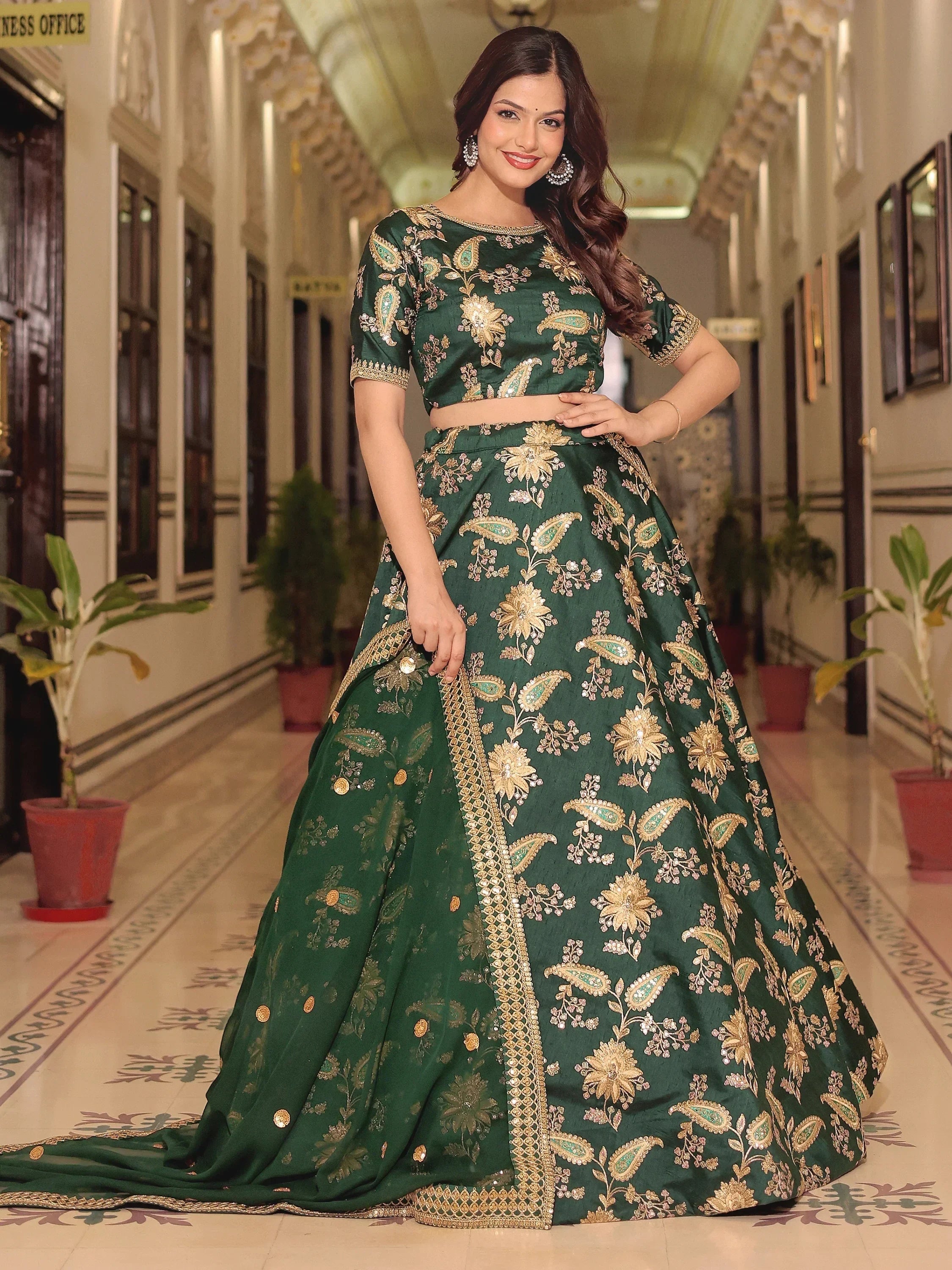 Emerald green designer lehenga choli with gold floral embroidery, perfect for Indian weddings and festive occasions.